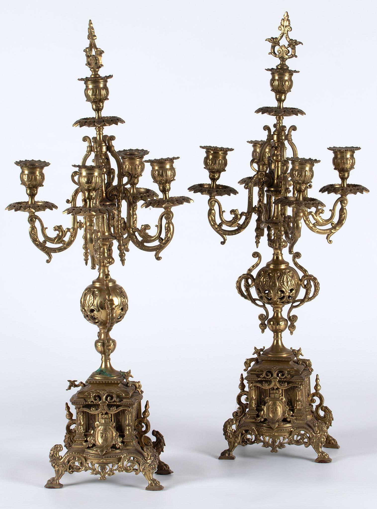 A Pair of Mixed Metal Decorative Candelabras: Continental, early 20th century. A pair of foliate and mythological brass and bronze five light candelabras; ht. 25, wd. 10, dp. 10 inches. Overall in good condition. One has repair to the joining of