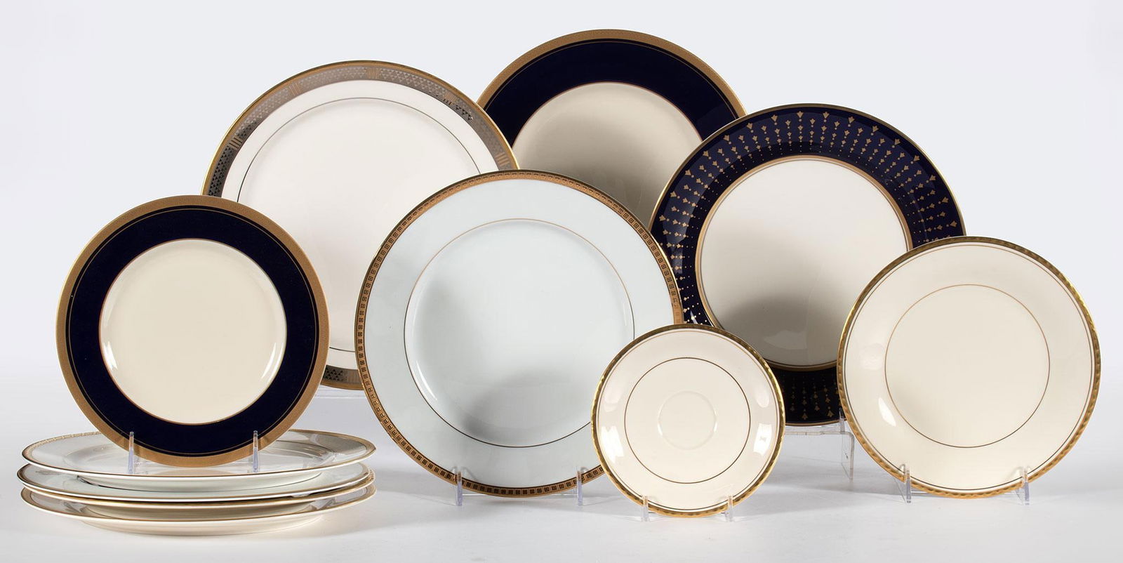 A Grouping of Gold Trim Fine China by Pickard: Lot includes 11 porcelain gold trimmed dishes by Pickard and single dinner plate by Bernardaud Limoges, consisting of 8 dinner plates, two salad plates and a single saucer. Patterns include Bernardaud