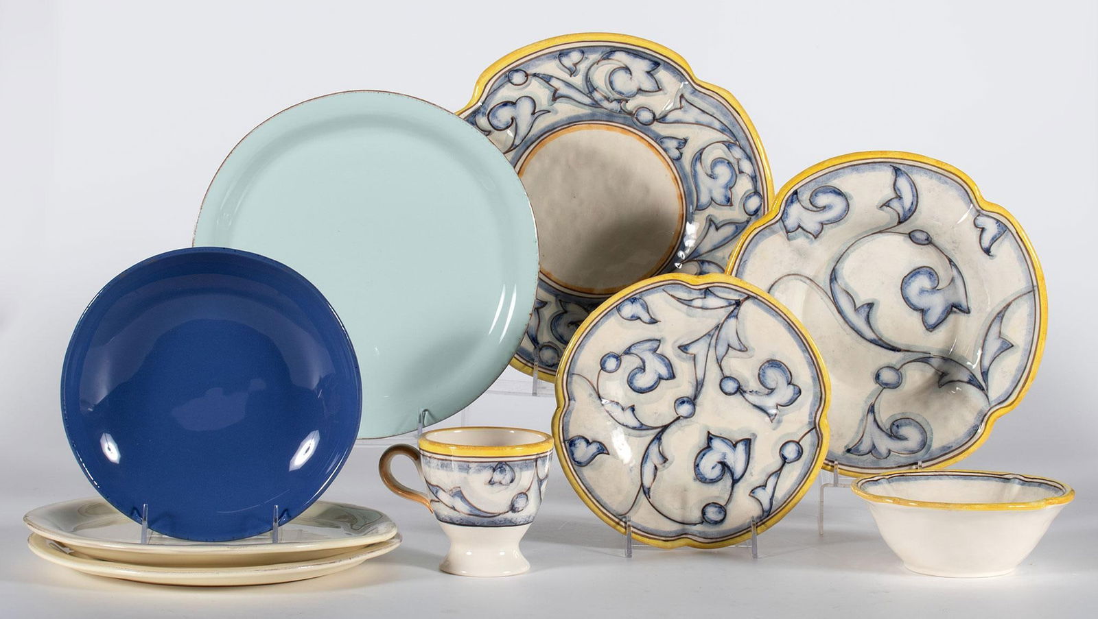Grouping of Italian Vietri Dinnerware Pieces: Italian, 20th century. A group of 9 various patterned Vietri dinnerware pieces, including 4 dinner plates, single salad plate, single mug, and 2 bowls; largest diameter 10.5 inches. Overall good condi
