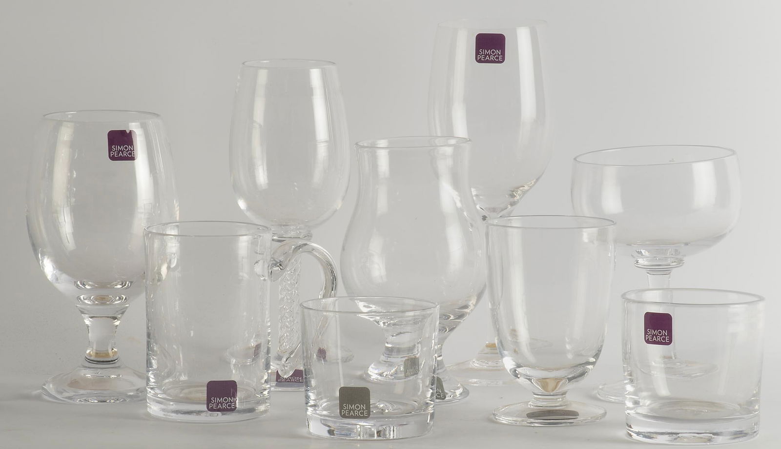 Simon Pearce Various Stemware: Lot includes 8 various wine goblets, two handled mugs plus 6 tumblers; ht. 9 inches. Overall good condition.