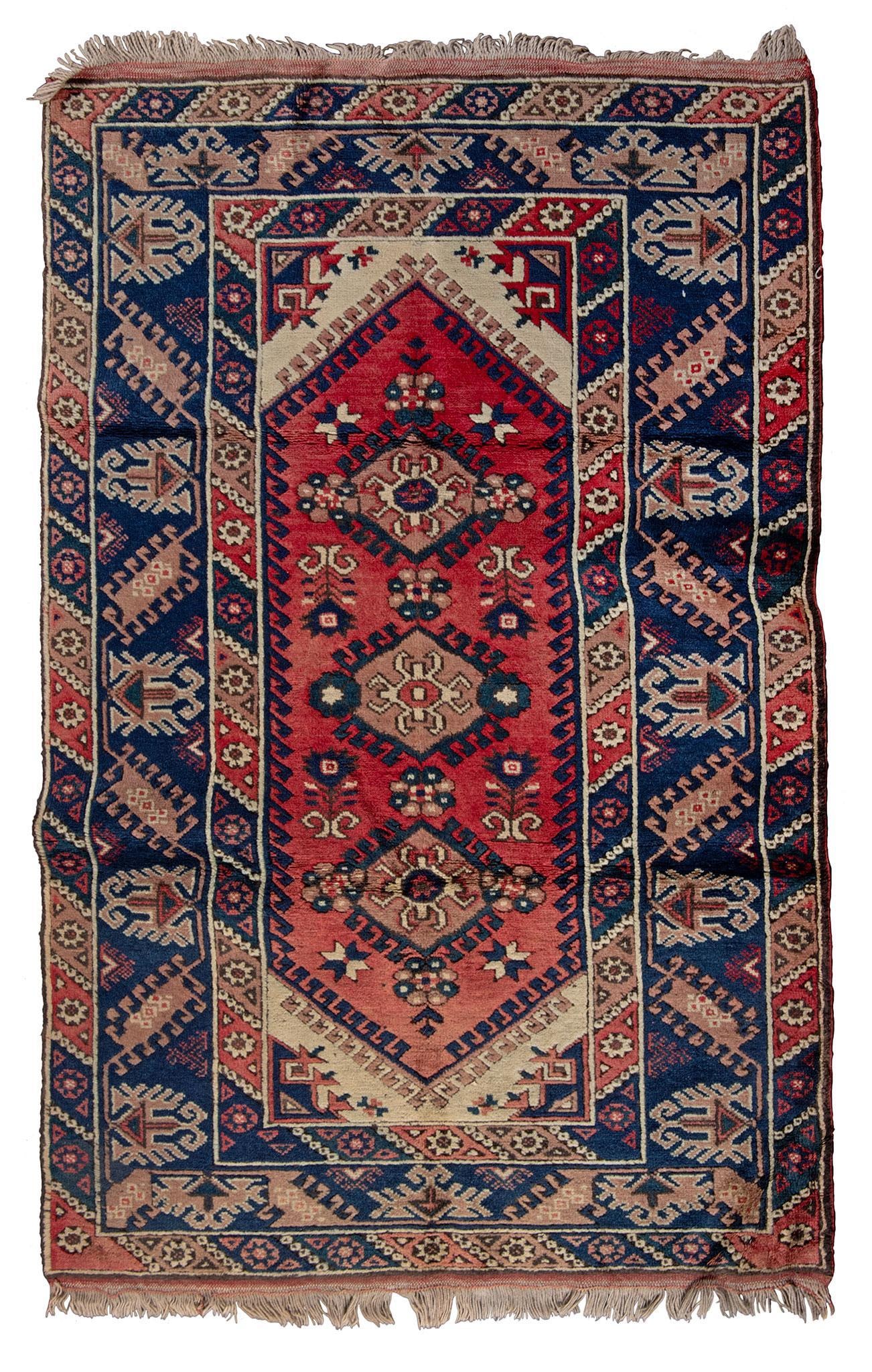 A Kazak Area Rug: Kazak, 20th century. 77 x 49 inches. Overall good condition.