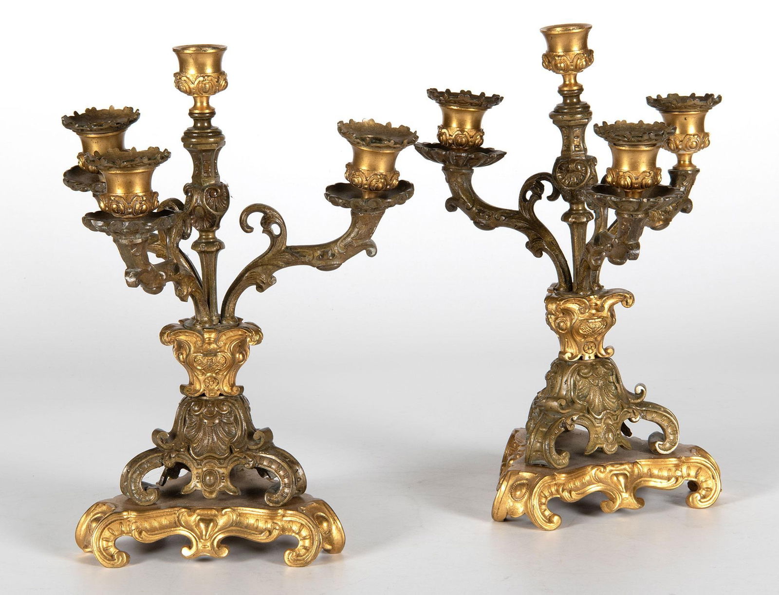 A Pair of French Ormolu Candelabras: French, 20th century. A pair of unmarked pot metal and ormolu 4 light candelabras, overall acanthus leaf and shell decoration; ht. 12.5, wd. 10, dp. 8 inches. Overall good condition.