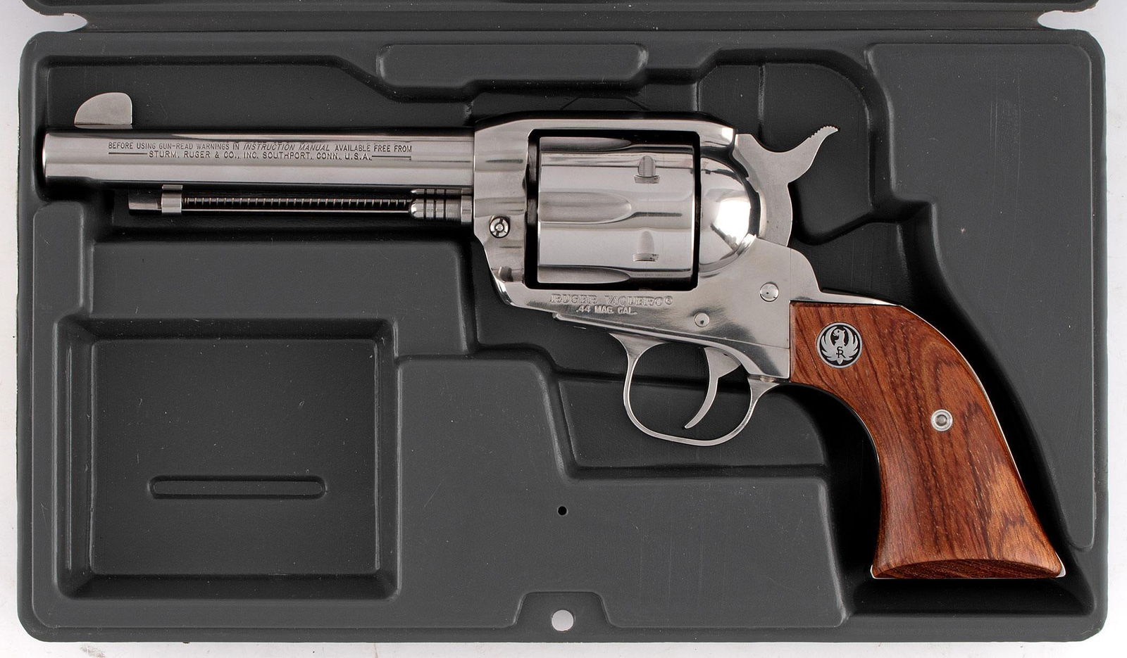 *Ruger Stainless Steel Vaquero Single Action Revolver: .44 mag, 5.5" barrel, S/N 56-76964. Stainless steel, wood grips with Ruger Medallions. This revolver is like new in the original box.