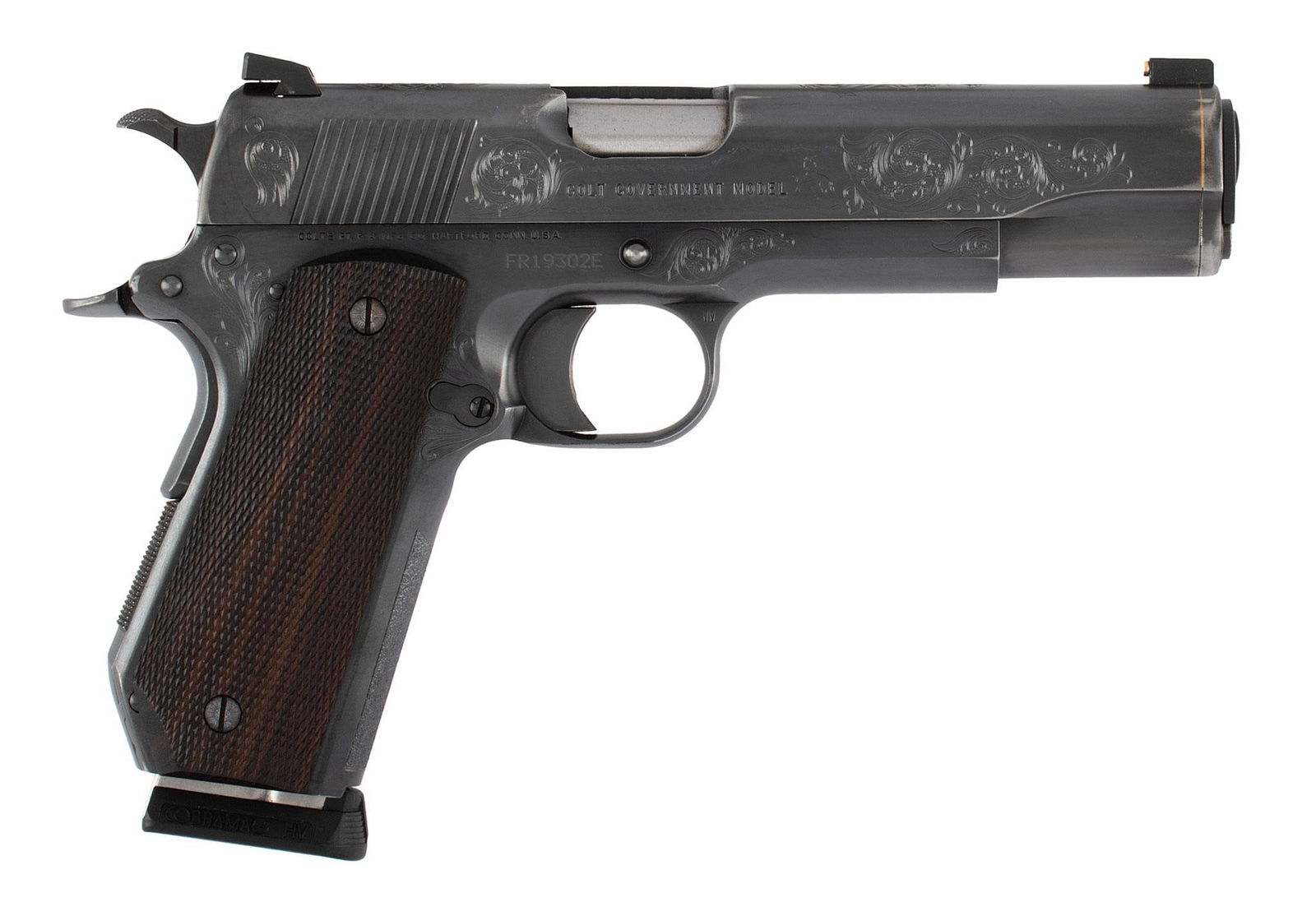 **Custom Engraved Colt Mk IV Series 80 1911 Government Model: 9X23 WIN caliber, 5" barrel, S/N FR19302E. Blue finish, scroll engraving with a stippled background. Finely checkered wood grips. Target sights. A gold band inlaid around the muzzle. This pistol