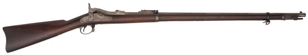 Springfield Model 1884 Trapdoor Rifle: .45-70 caliber, 32.5" barrel length, S/N 558100. Blued barrel with two-band walnut stock. Blade front sight with Buffington pattern rear sight. Stock shows 1892 cartouche with script " P" proof