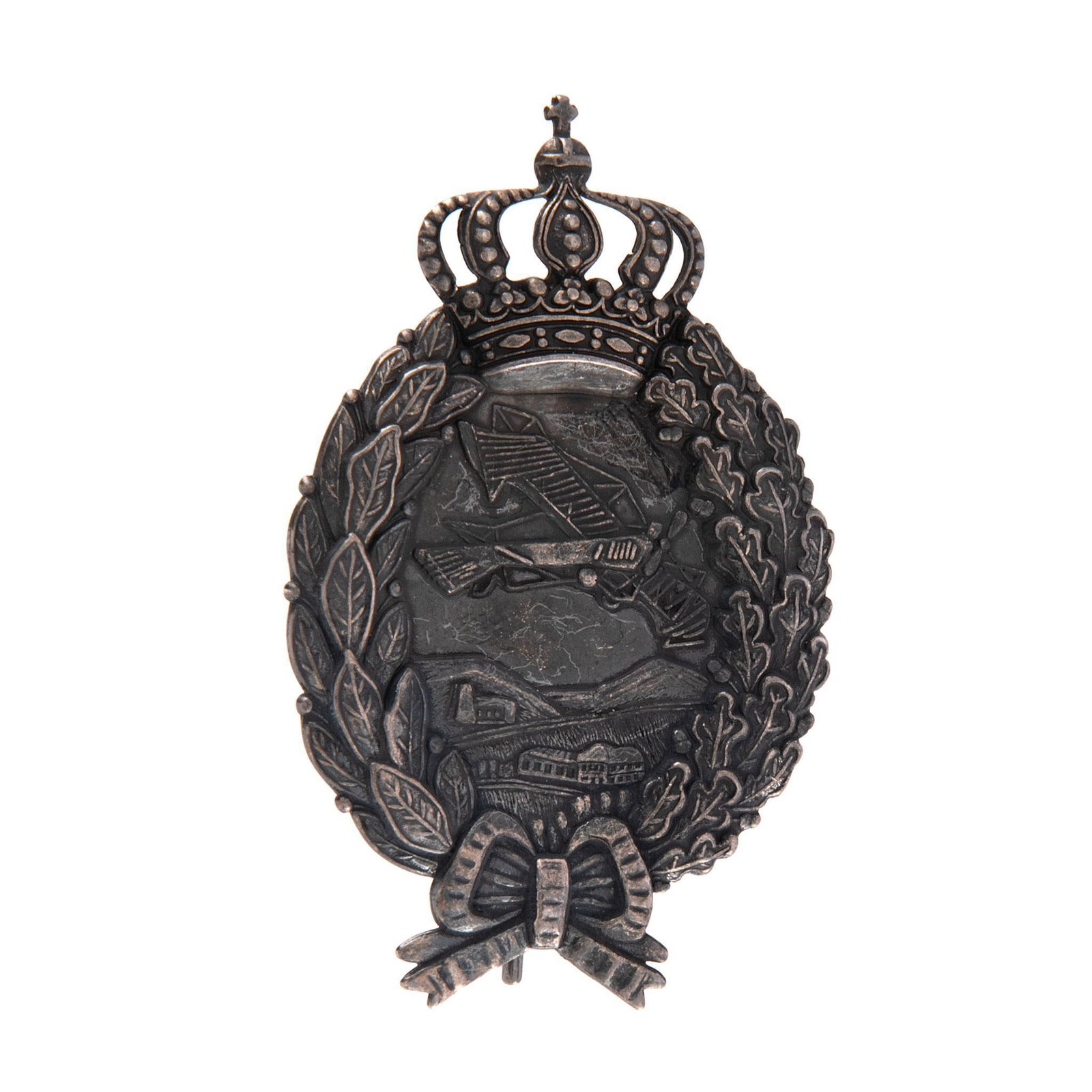 Imperial German WWI Aero Bavarian Aviator Pilot Badge: Lot includes an Imperial German WWI Aero Bavarian Aviator Pilot Badge. Measures 1 3/4'' wide by 2 3/4'' tall. The front shows an airplane flying over some buildings and small mountains in the center.