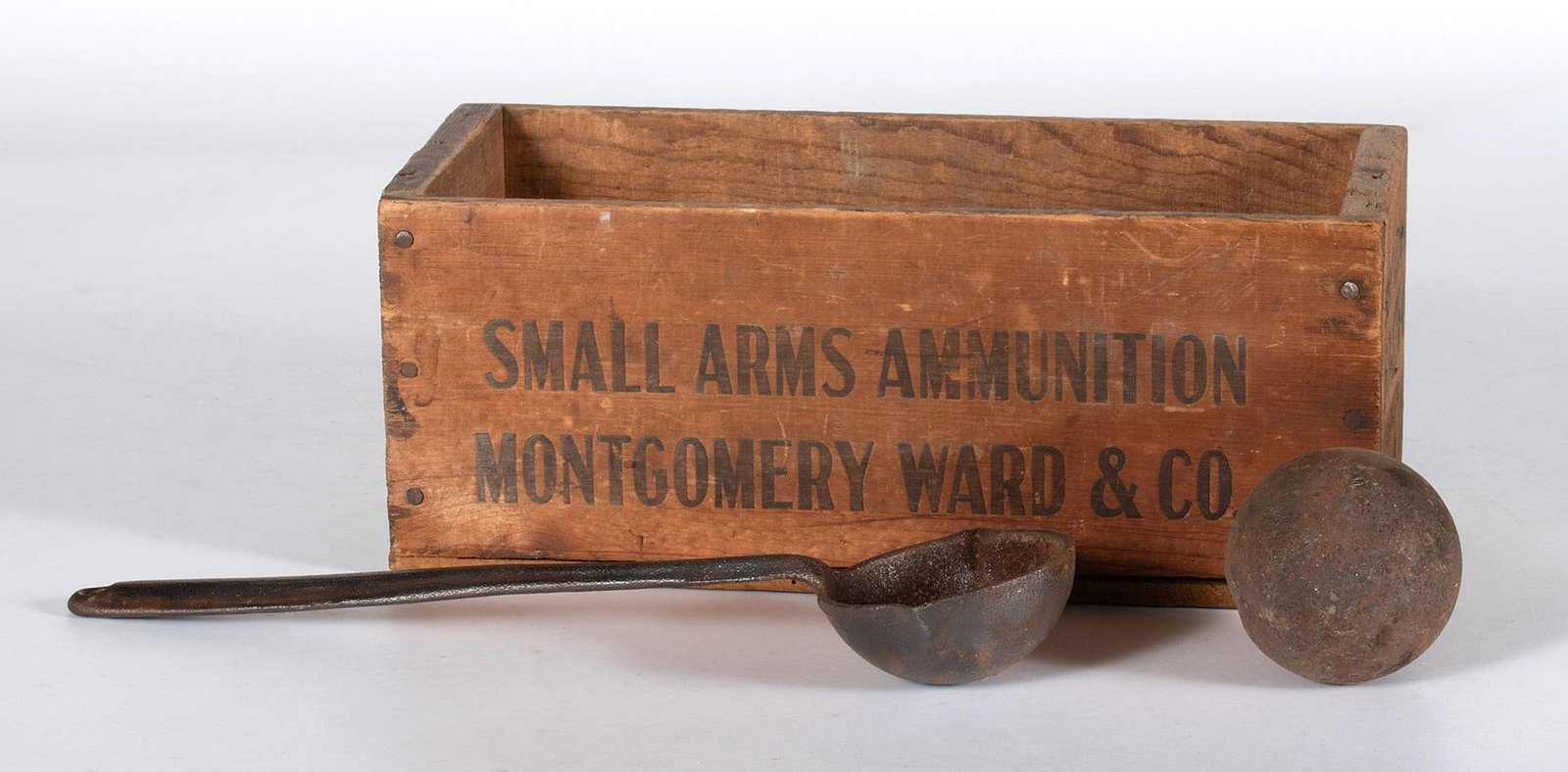 Crated Lead balls with Wooden Crate: Lot includes a vintage wooden box marked "Small Arms Ammunition Montgomery Ward & Co". Also includes several lead balls and a lead pouring spoon.