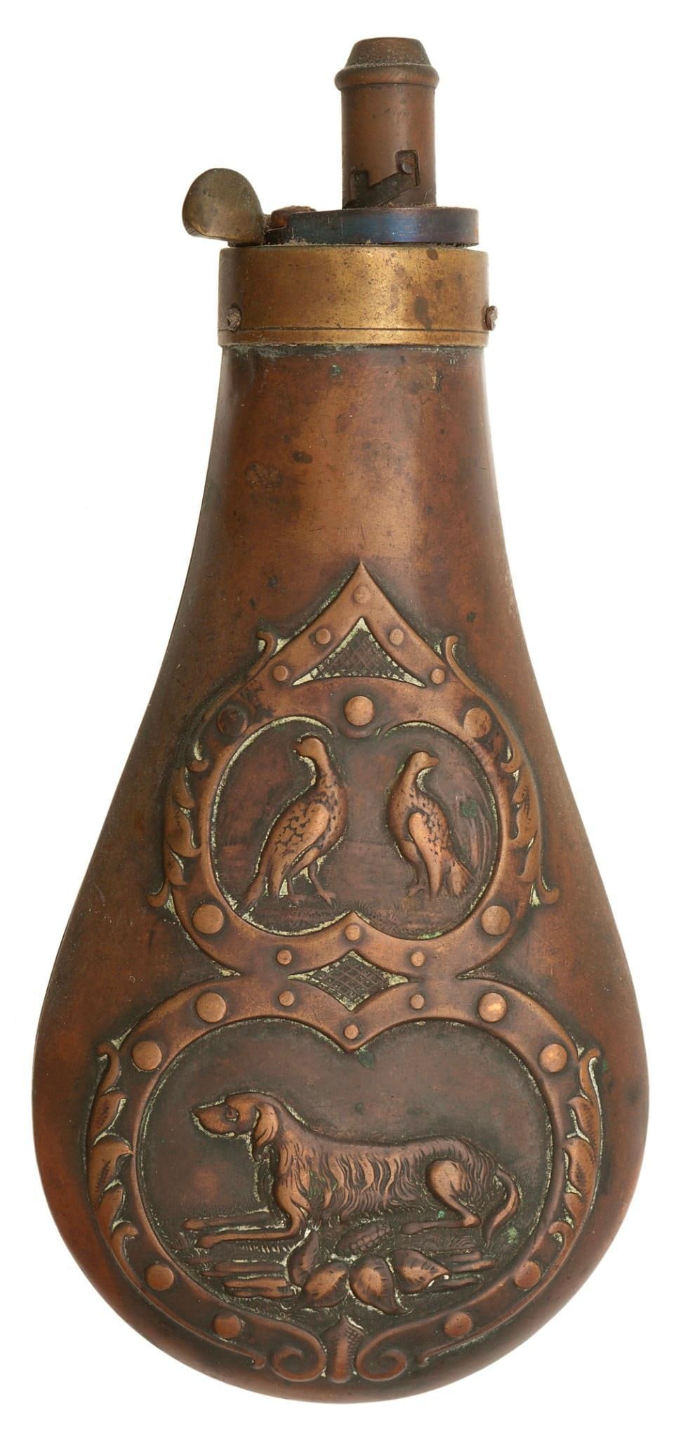 Early Remington Powder Flask: 6.25" with two birds in a panel and a bird dog along the bottom. Brass, with a small adjustable spout. Good to very good condition.