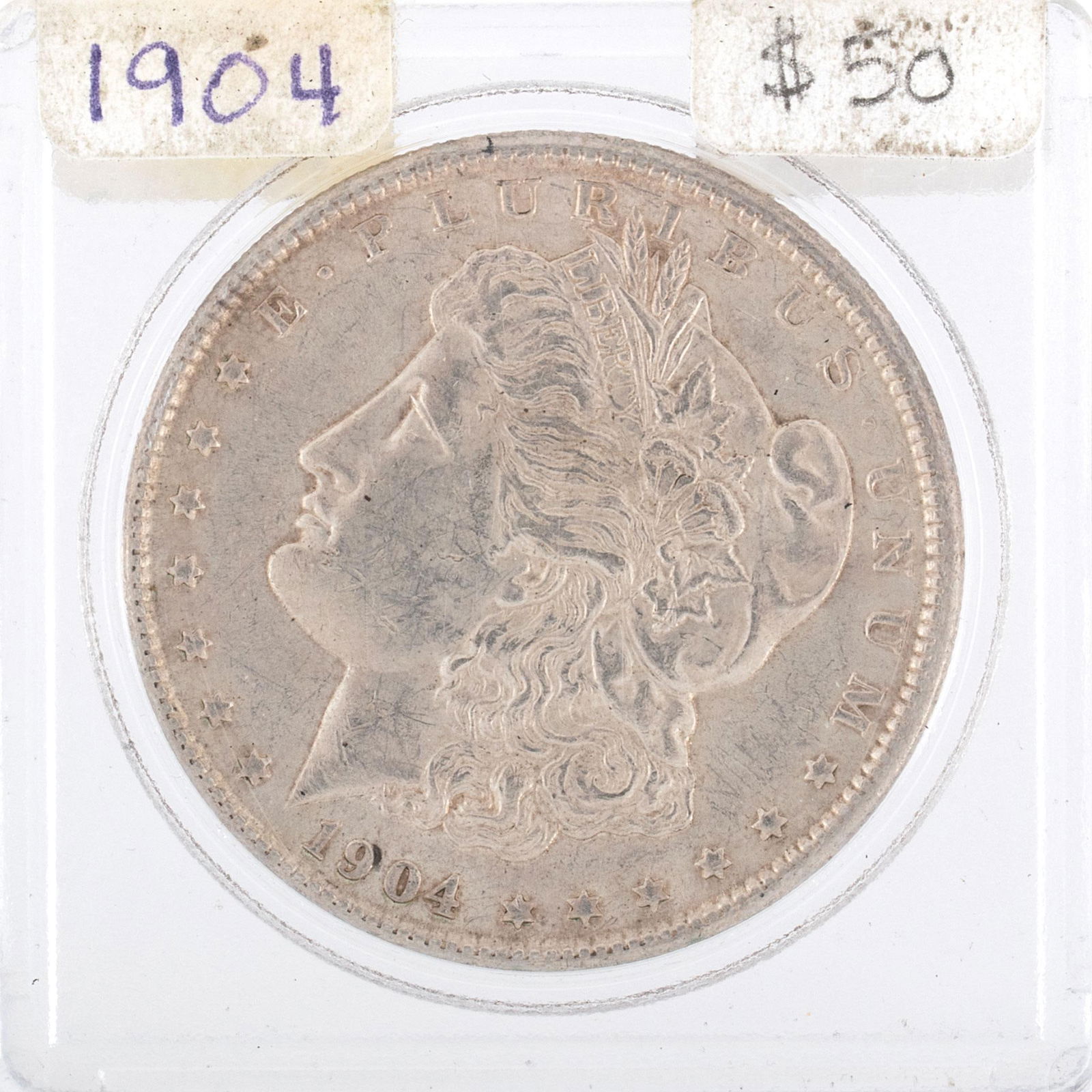 United States Silver Morgan Dollar Coin: A United States 1904 silver Morgan dollar ungraded coin in case. Very good condition.