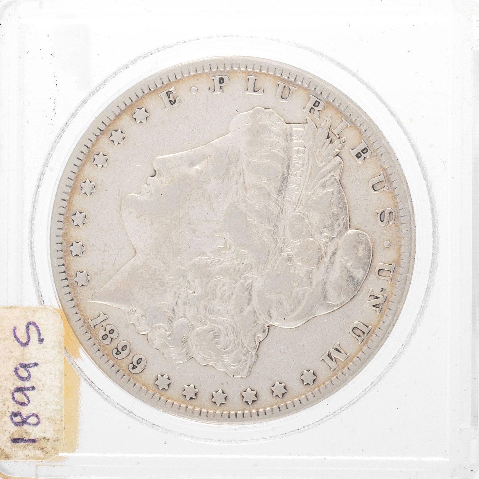 United States 1899 Silver Morgan Dollar Coin: A United States 1899-S silver Morgan dollar ungraded coin in case. Good condition.