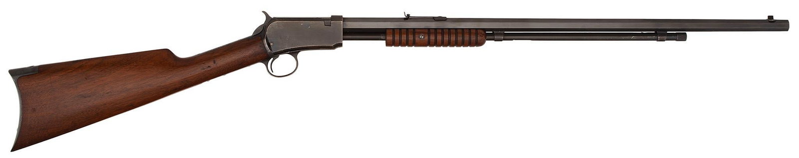 ** Winchester Model 1890 Rifle: .22 Long caliber, 24" octagonal barrel, S/N 460879. Blue finish with grooved forearm and plain walnut stock.This is a very strong Model 1890 rifle with a lot of original blue finish. Circa 1911 manufa