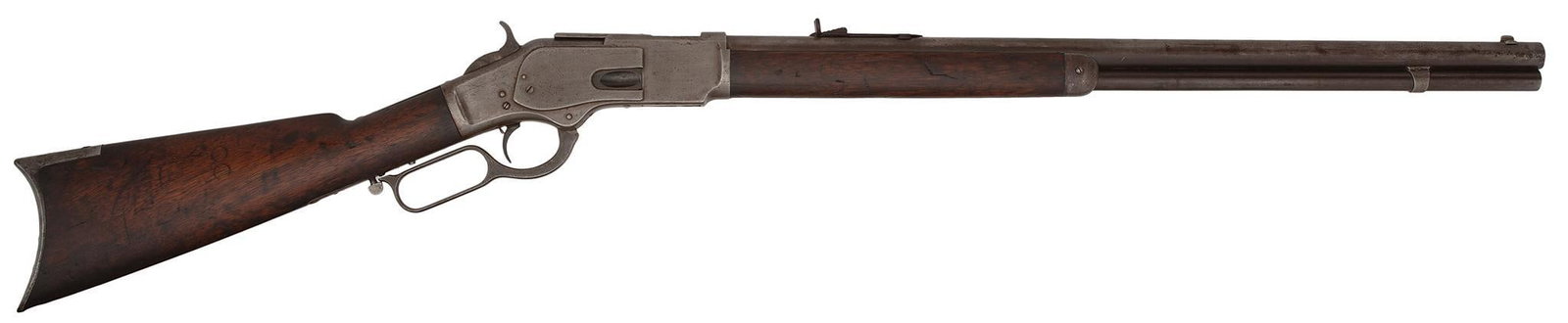 Winchester First Model 1873 Lever Action Rifle: 44-40 caliber, 24" Round barrel full magazine, S/N 6117. Thumb print dust cover with raised rails. Standard rifle sights front and rear, single set trigger. All metal is smooth and gray mixed with plu