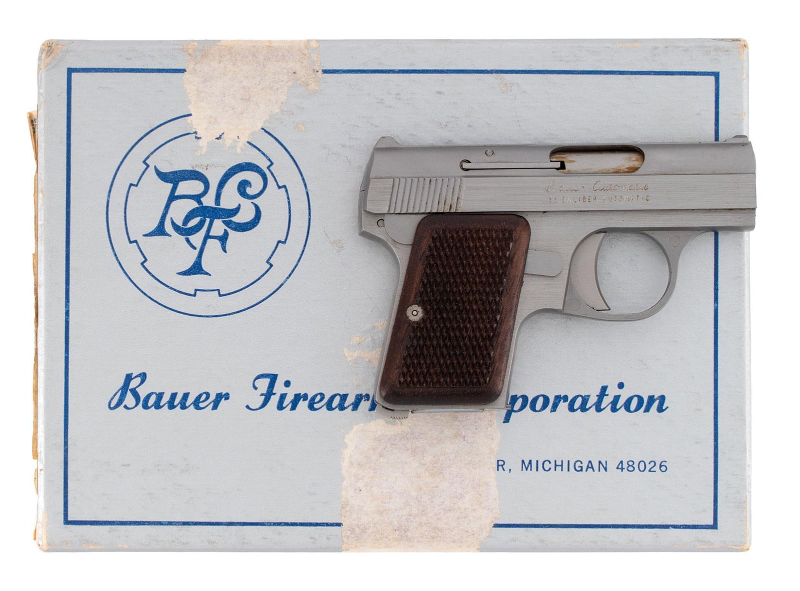 * Bauer Firearms Corp Semi Auto Pistol: .25 ACP caliber, 2 1/8" barrel, S/N 028781. Stainless steel, checkered walnut grips, in original box with zipper pouch and paperwork. **Like new in the box.