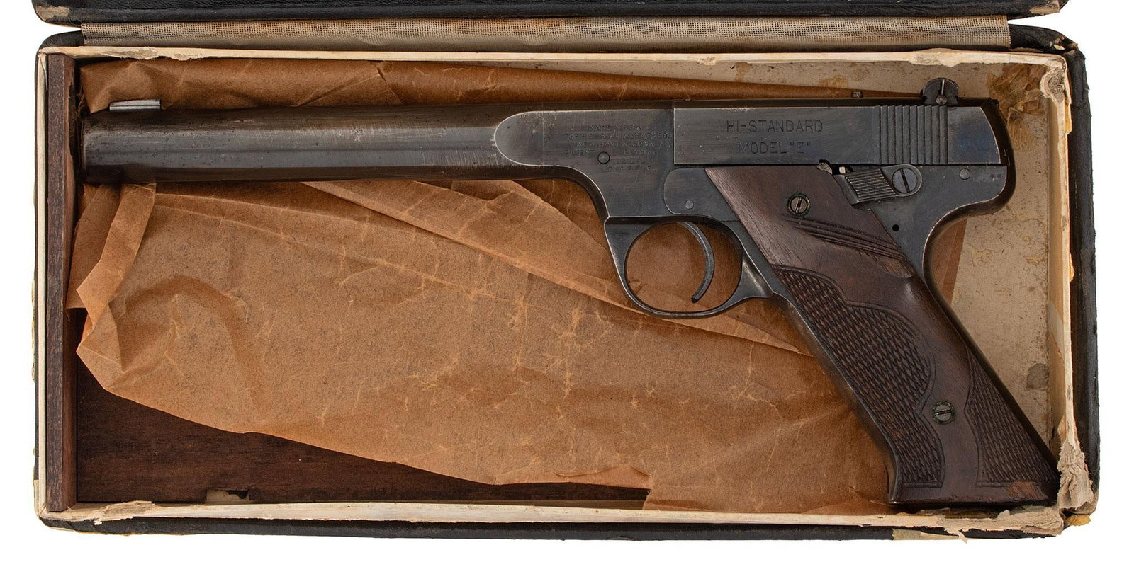 ** Hi-Standard Model E Target Pistol: .22 long rifle caliber, 6.75" barrel length, S/N 57686. Left side of the frame marked with address and caliber. The left side of the slide marked "Hi-Standard" over "Model E". Front blade sight and