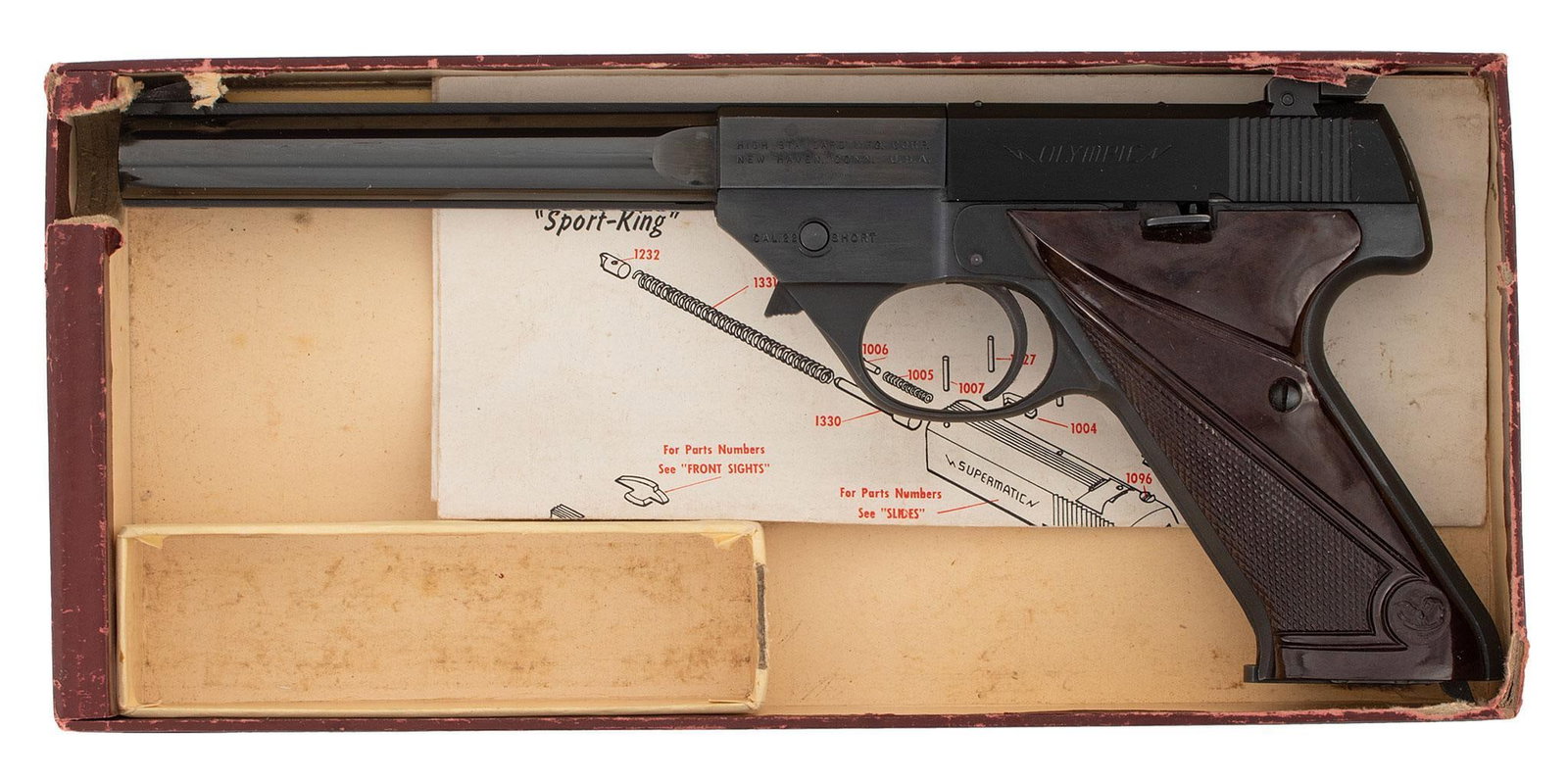 ** Hi-Standard Olympic Pistol in Box: .22 short caliber, 6.5" barrel length, S/N 412718. Left side of the frame marked in 2 lines with address over caliber markings. Left side of the slide marked "Olympic". Front ramp blade sight and rear