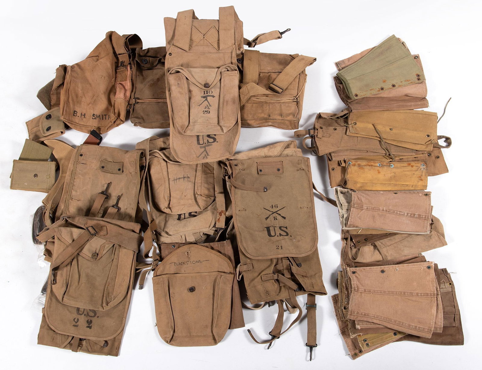 Lot of US Field Gear: Machine gunner’s backpack sack, gas masks in the canvas bags. Belts and straps, along with miscellaneous items. Very good overall.
