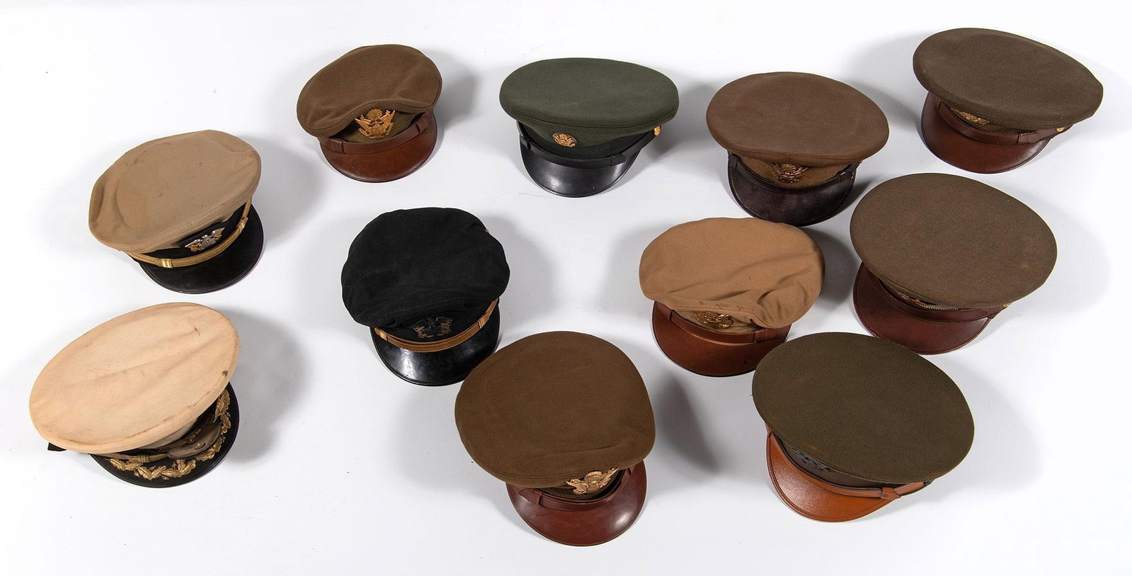 Grouping of US Amy Garrison Caps: Group of 11 U.S. Army and Navy visor caps. All in very good to excellent condition.