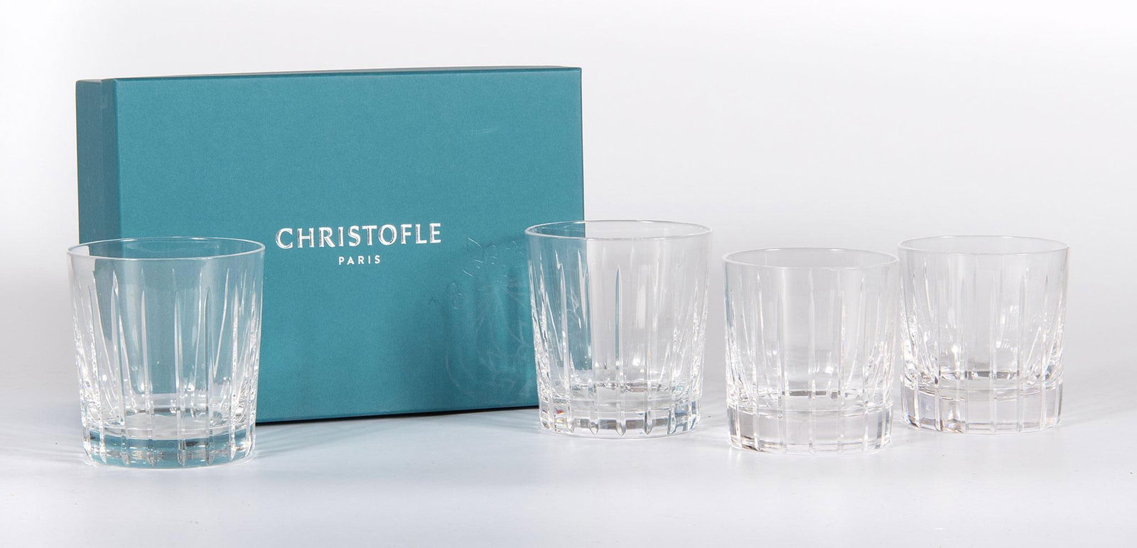 Christofle Iriana Old Fashion and High Boy Stemware: Lot includes 12 Christofle Old Fashion crystal tumblers and 4 High Boy stemware in the Iriana pattern, all new in boxes and very good condition.