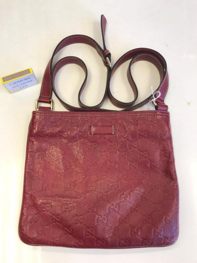 Gucci handbag in red embossed leather. 245 mm wide 210: Gucci handbag in red embossed leather.245 mm wide 210 mm height. Very slight wear to colour at lower corners, otherwise fine condition