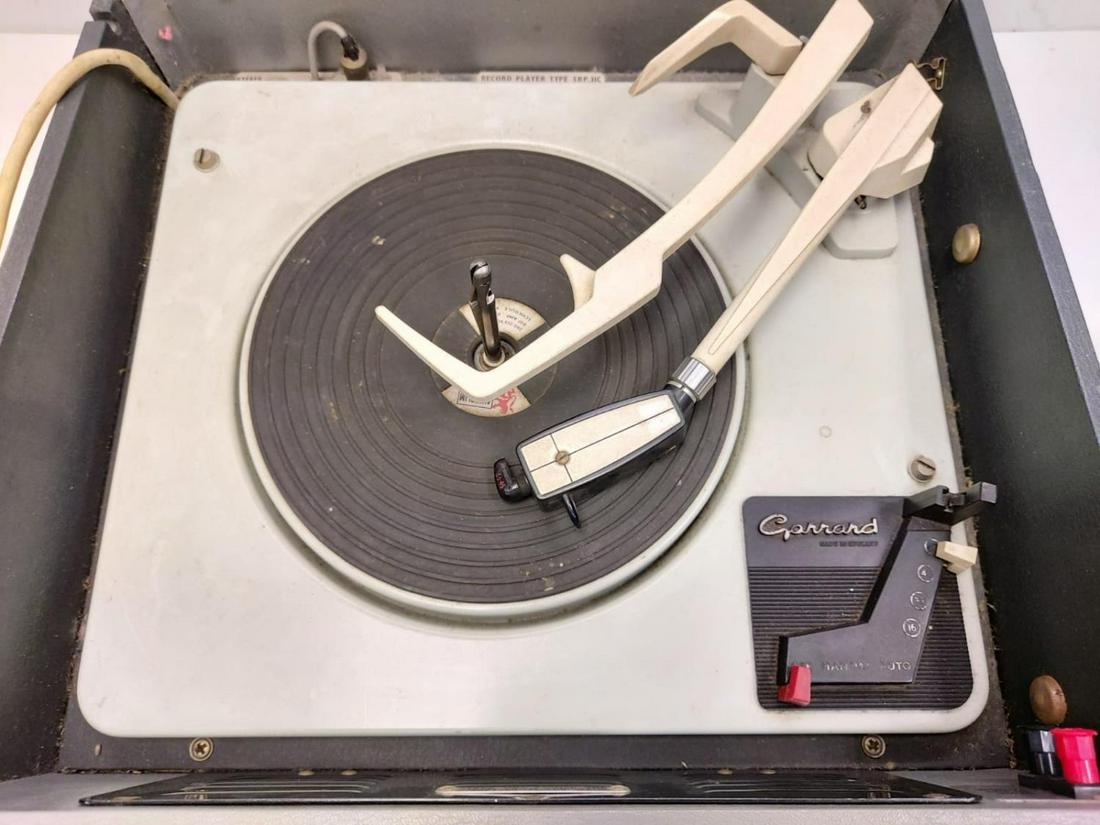 A vintage 1960's Bush SRP31 portable record player: A vintage 1960's Bush SRP31 portable record player featuring a Garrod record deck. In working order. 38x38cm.