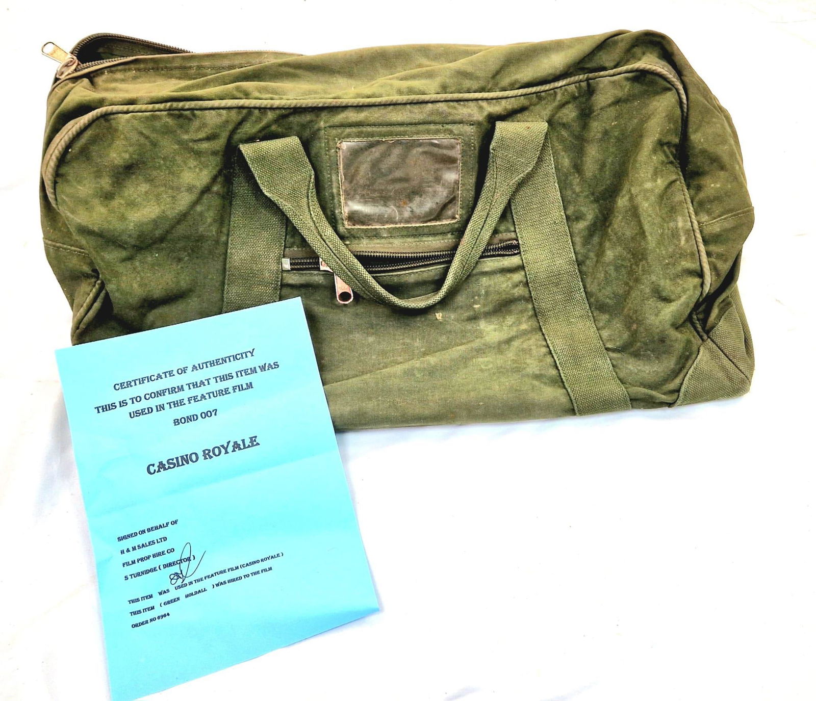 James Bond Casino Royale Movie Prop Memorabilia. Original 007 Royal Green Holdall Bag (one of 20): James Bond Casino Royale Movie Prop Memorabilia. Original 007 Royal Green Holdall Bag (one of 20) used in the Daniel Craig Casino Royale movie. Comes with COA and purchase order paperwork. 60 x 35cm.