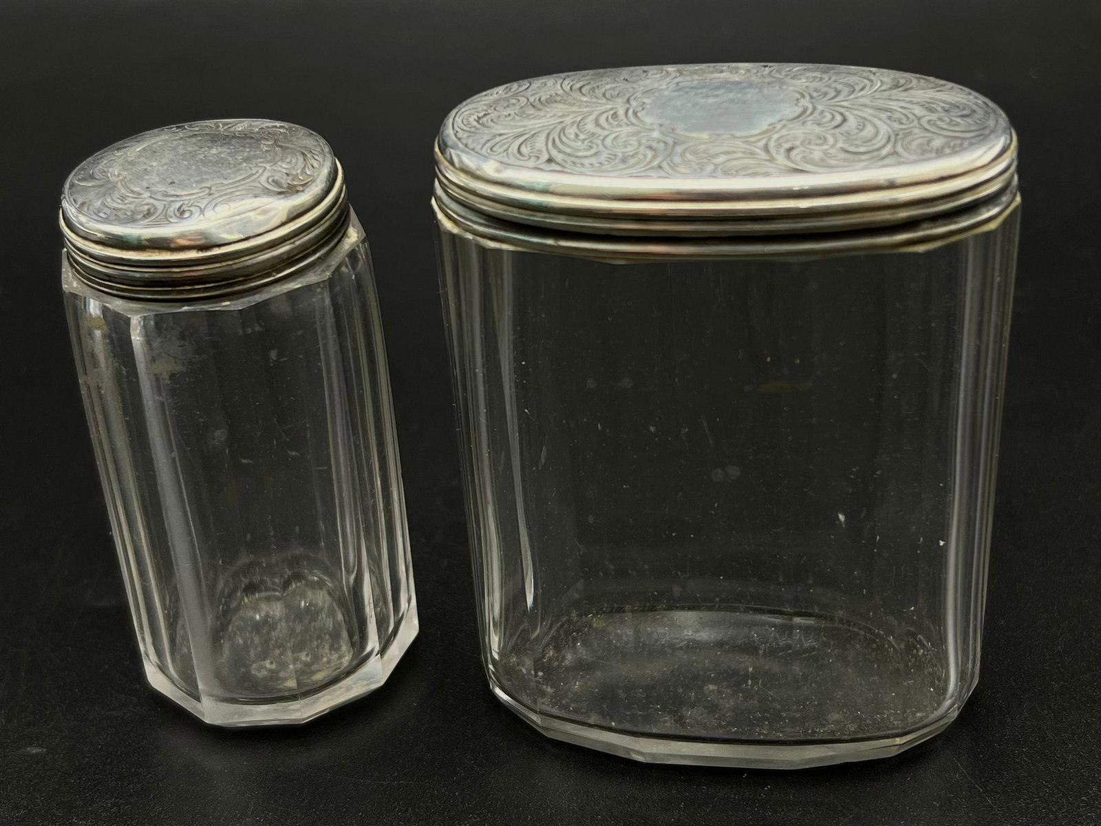 Two Victorian Glass and 925 Silver Lidded Containers. Circular and oval. Hallmarks for London 1876.: Two Victorian Glass and 925 Silver Lidded Containers. Circular and oval. Hallmarks for London 1876. Thomas Johnson makers mark. 8.5cm x 7cm and 8cm x 35mm.