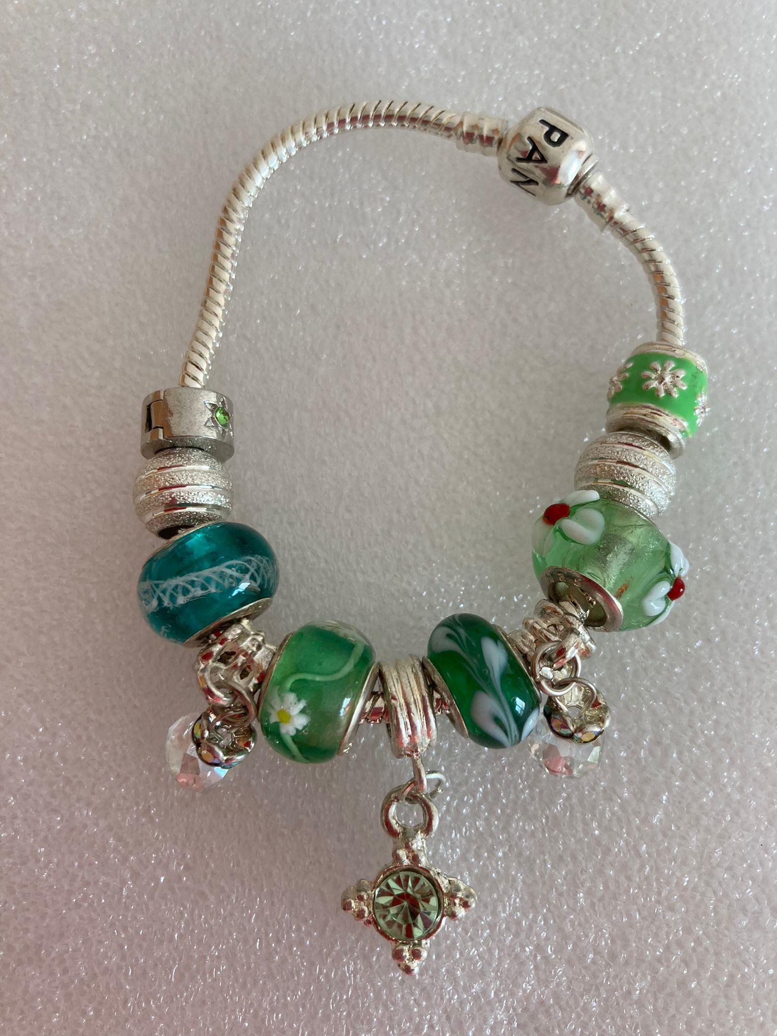SILVER BRACELET marked PANDORA Having Silver Sided charms and others in shades of green and silver.: SILVER BRACELET marked PANDORA Having Silver Sided charms and others in shades of green and silver. 19 cm.