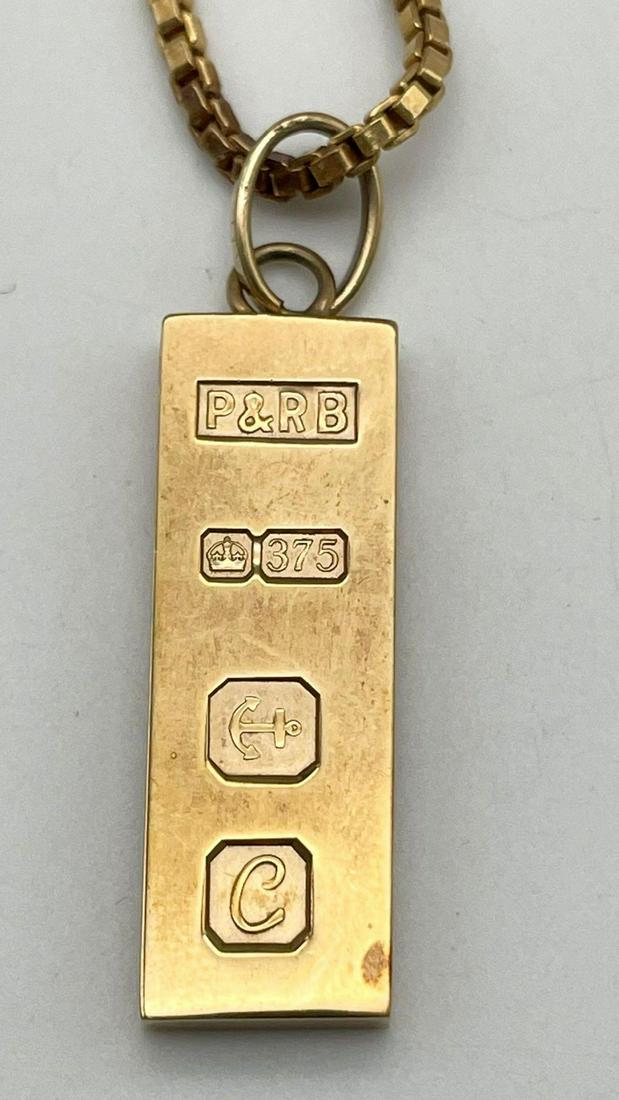 A 9K Yellow Gold UK Hallmarked Ingot Pendant on a 9K Yellow Gold Chain/Necklace. P and R Bushell: A 9K Yellow Gold UK Hallmarked Ingot Pendant on a 9K Yellow Gold Chain/Necklace. P and R Bushell makers mark. Ingot-3.5cm. Necklace - 48cm. 22.27g total weight.