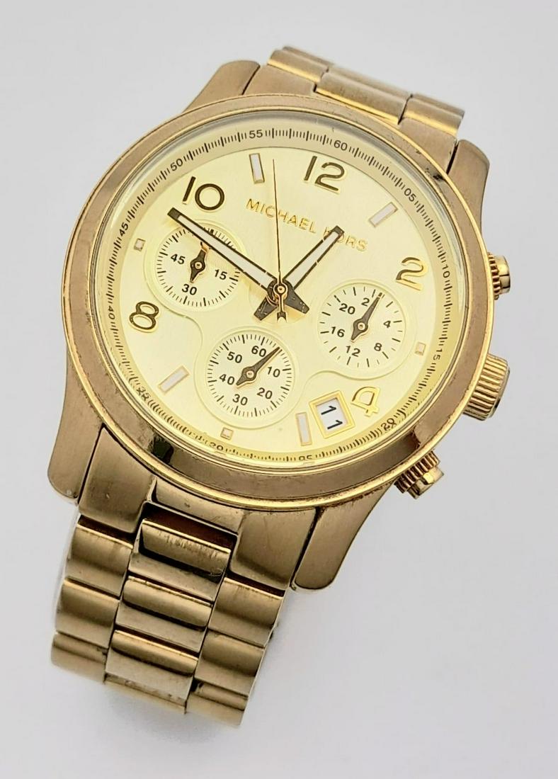 A Michael Kors Gold Plated Ladies Chronograph Watch. Gold plated bracelet and case - 38mm. Gold tone: A Michael Kors Gold Plated Ladies Chronograph Watch. Gold plated bracelet and case - 38mm. Gold tone dial with three sub dials. Quartz movement. In good condition and working order.