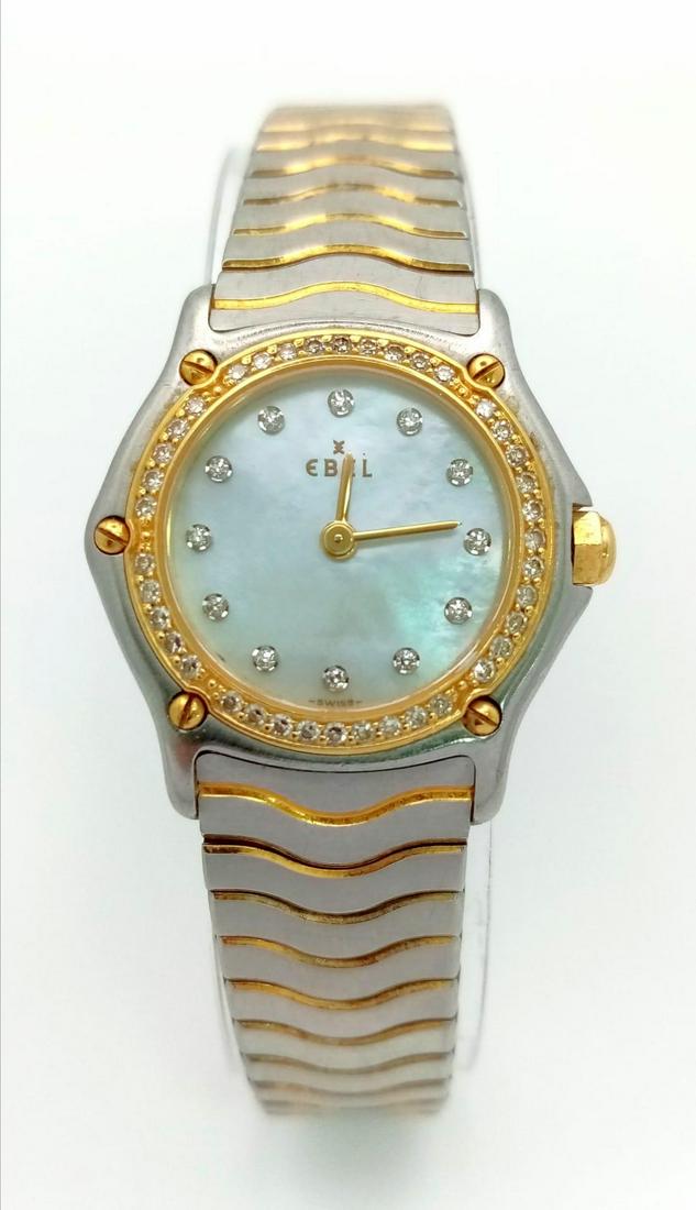 An Ebel Ladies Wave Mother of Pearl Quartz Watch. Two-tone bracelet (24k gold electroplated waves): An Ebel Ladies Wave Mother of Pearl Quartz Watch. Two-tone bracelet (24k gold electroplated waves) and case - 23mm. Diamond bezel. Mother of pearl dial with diamond markers. In working order. Comes wi