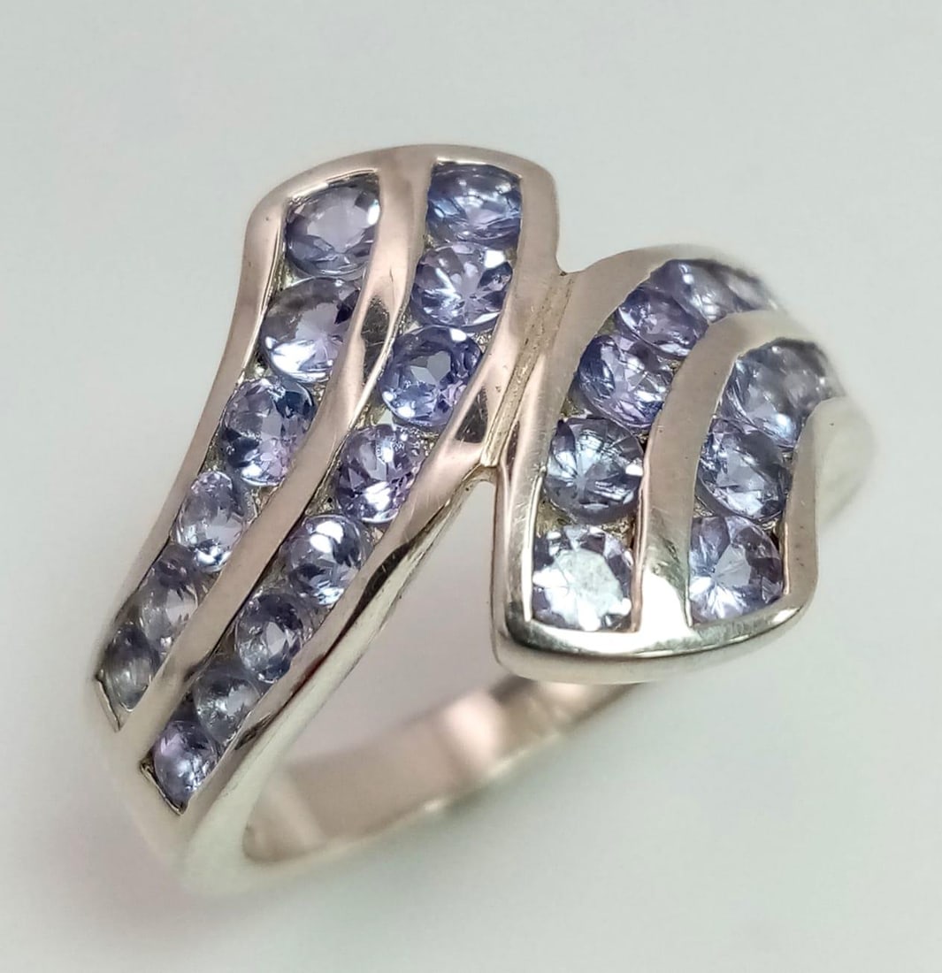An Ex. Display Sterling Silver and Channel Set Tanzanite Ring Size M. Set with four rows of round: An Ex. Display Sterling Silver and Channel Set Tanzanite Ring Size M. Set with four rows of round cut Tanzanites the Ring Measures 1.6cm Width at the Crown and Weighs 4.56 Grams.