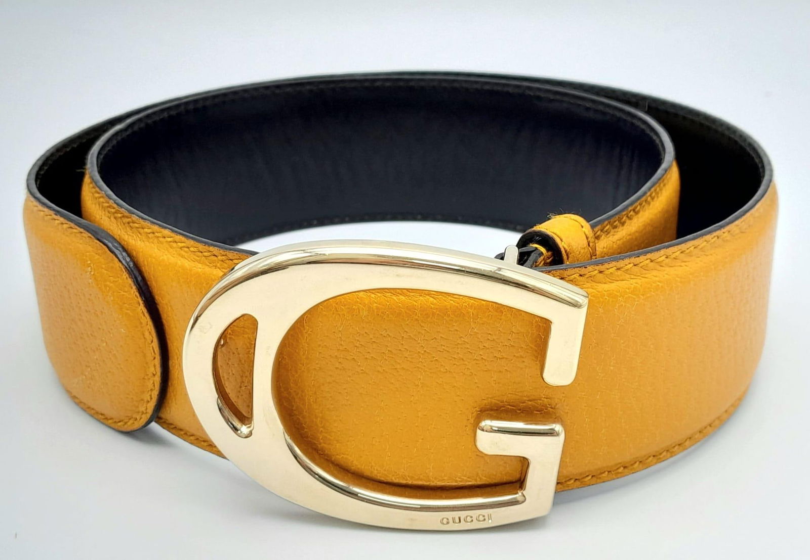 A Gucci Yellow Leather Wide Fashion Belt. Gucci 'G' metal buckle. 95cm length. 5cm width. In good: A Gucci Yellow Leather Wide Fashion Belt. Gucci 'G' metal buckle. 95cm length. 5cm width. In good condition but please see photos.