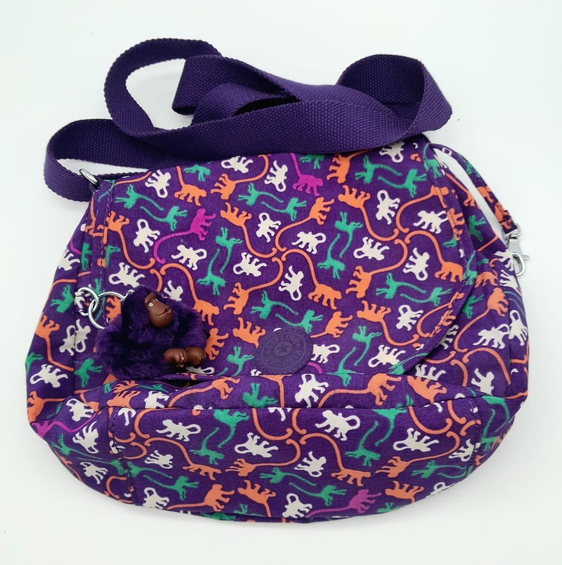 A Kipling Monkey Pattern Textile Shoulder-bag. Comes with an adjustable shoulder strap and a hanging: A Kipling Monkey Pattern Textile Shoulder-bag. Comes with an adjustable shoulder strap and a hanging monkey mascot.25cm x 20cm.