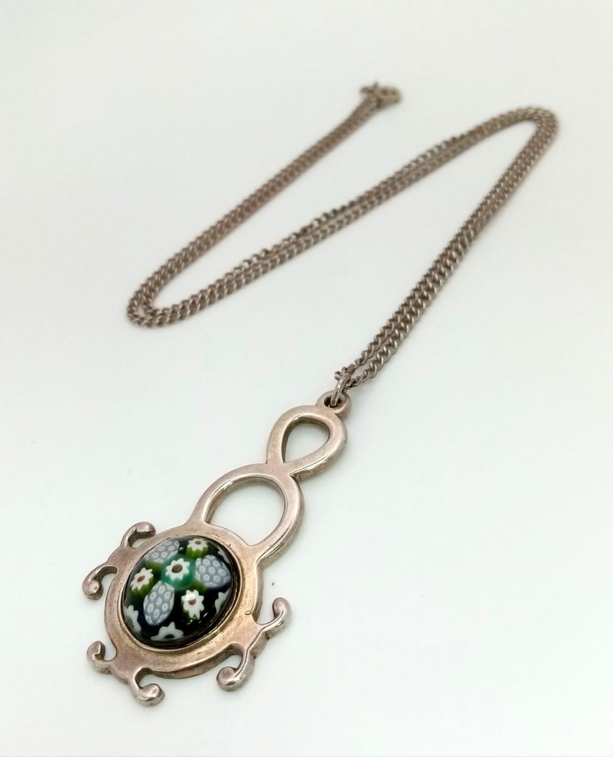 A Vintage Caithness Glass Silver Pendant on a white metal chain. 4.5cm and 50cm.: A Vintage Caithness Glass Silver Pendant on a white metal chain. 4.5cm and 50cm.