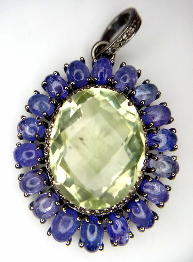A Green Amethyst with Tanzanite and Rose-Cut Diamond Halos Pendant. Set in 925 silver. Amethyst -: A Green Amethyst with Tanzanite and Rose-Cut Diamond Halos Pendant. Set in 925 silver. Amethyst - 30.50ct. Diamonds - 0.40ctw. 4.5cm. 11.22g total weight. Comes with a presentation case.