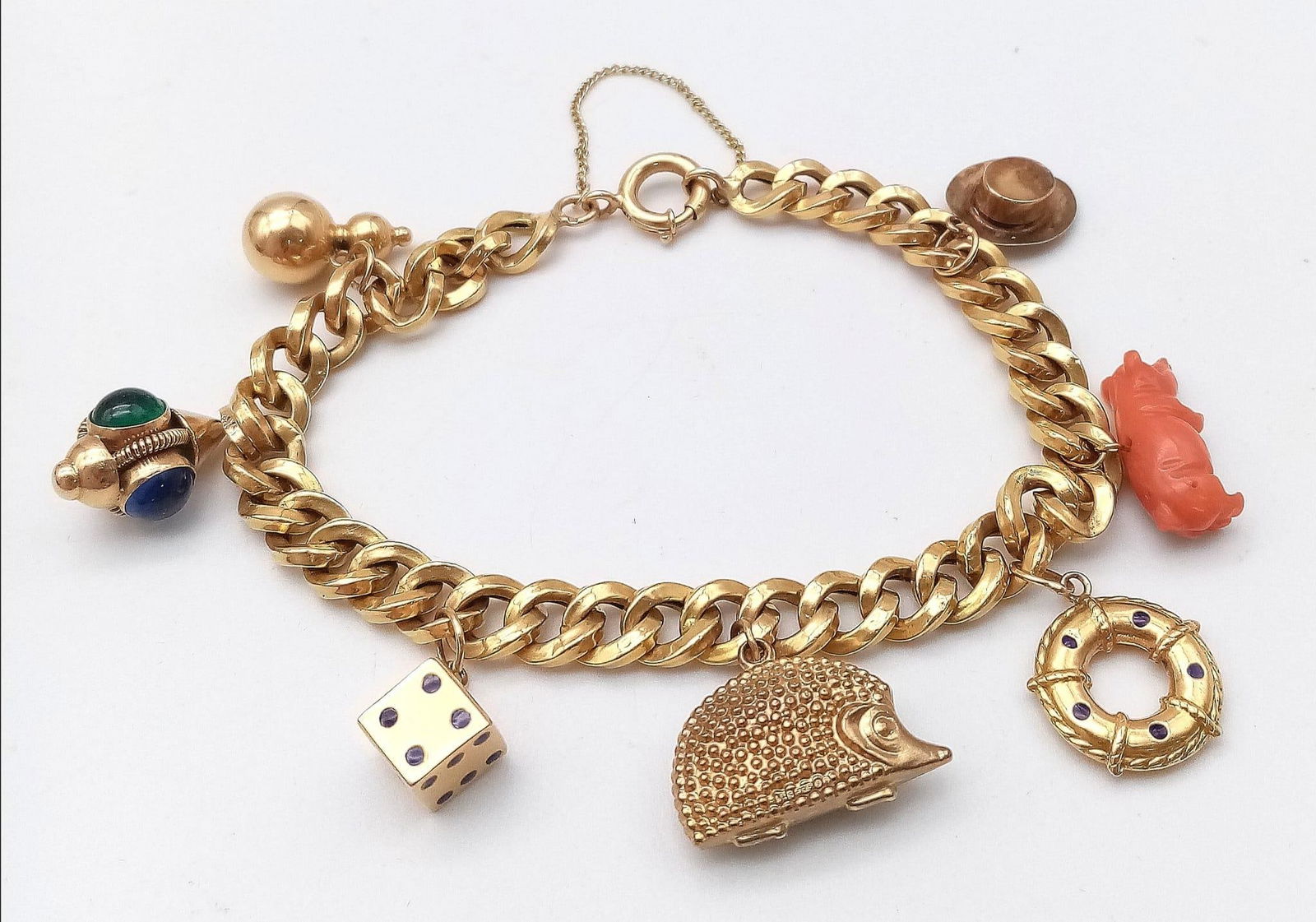 AHEAVY 18K GOLD BRACELET WITH AN ASSORTMENT OF 9K, 14K AND 18K GOLD CHARMS . 17.9gms: AHEAVY 18K GOLD BRACELET WITH AN ASSORTMENT OF 9K, 14K AND 18K GOLD CHARMS . 17.9gms