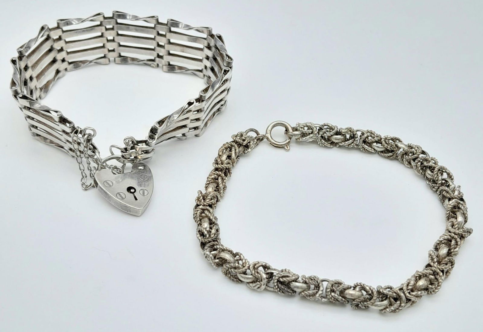 2X unique vintage silver bracelets with unique designs. One come with the heart padlock and fully: 2X unique vintage silver bracelets with unique designs. One come with the heart padlock and fully hallmarked: London, 1958. Total weight 34.43G. Total length 11cm.