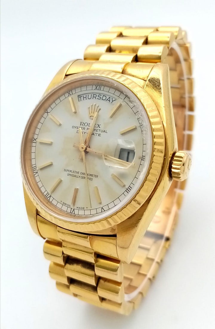 AN 18K GOLD ROLEX OYSTER PERPETUAL DAY-DATE WITH SOLID 18K GOLD STRAP , WHITE DIAL AND AUTOMATIC: AN 18K GOLD ROLEX OYSTER PERPETUAL DAY-DATE WITH SOLID 18K GOLD STRAP , WHITE DIAL AND AUTOMATIC MOVEMENT. 36mm (price reduced as dial needs cleaning)A GREAT OPPURTUNITY TO BUY A SOLID GOLD ROLEX AT A