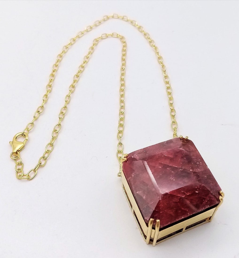 A Square-Cut 237ct Ruby Pendant in Gold Plated 925 Silver on a Gold Plated 925 Chain. Pendant 3cm x: A Square-Cut 237ct Ruby Pendant in Gold Plated 925 Silver on a Gold Plated 925 Chain. Pendant 3cm x 3cm. Chain - 44cm. Comes with a GRS Lab Certificate. 67g total weight. Comes with a presentation cas