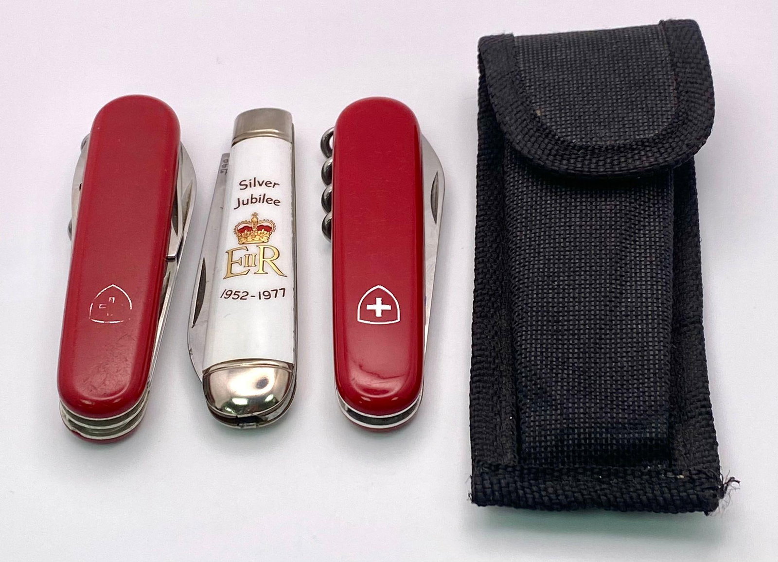 A collection of pocket knives. 1x Victorinox Huntsman Swiss Army Pocket Knife. 1x Richards of: A collection of pocket knives.1x Victorinox Huntsman Swiss Army Pocket Knife.1x Richards of Sheffield, Silver Jubilee Knife.1x Victorinox 3 Option Pocket Knife, comes with cover.
