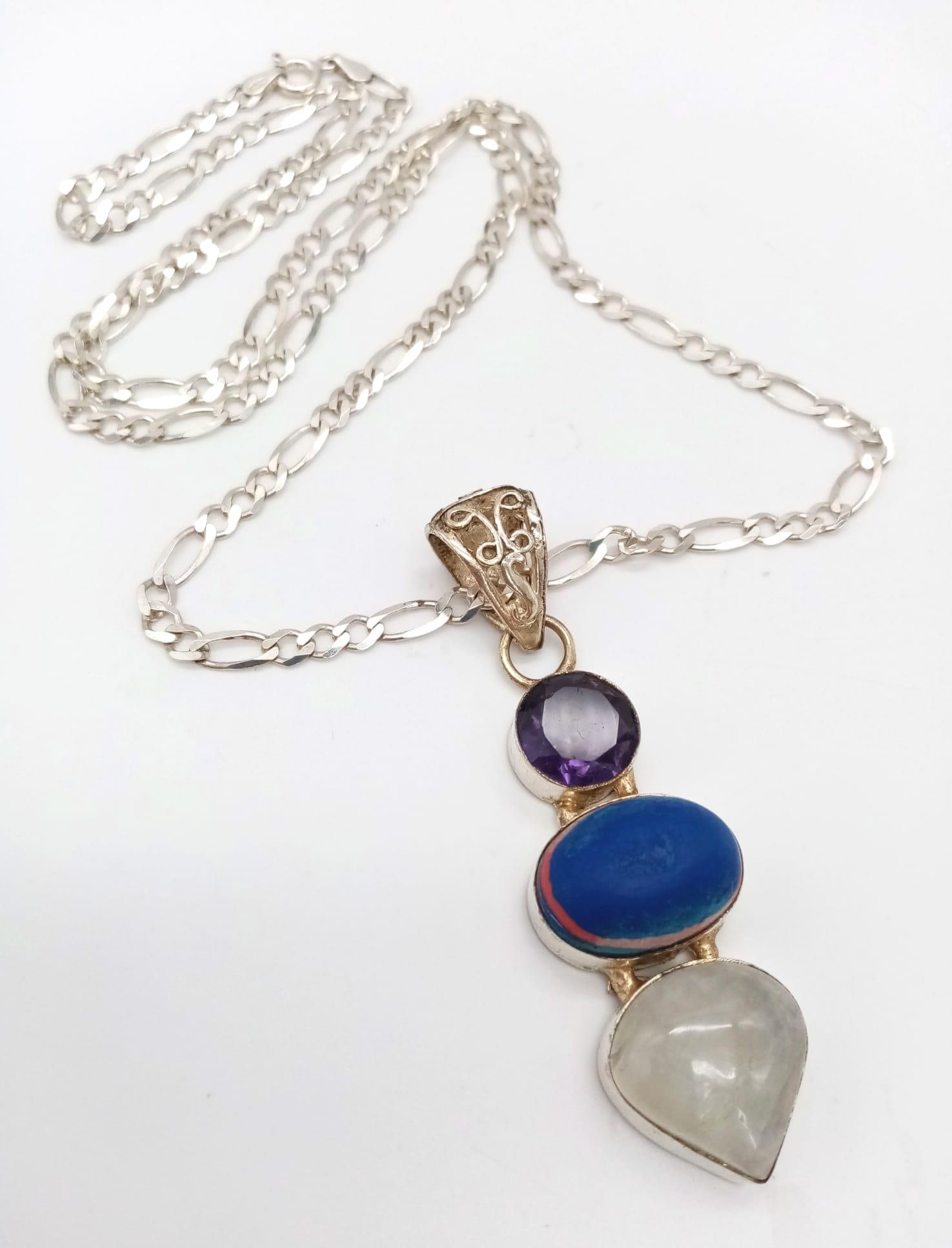 A Rare Vintage Sterling Silver Statement Necklace Set with Moonstone, Blue Obsidian and Amber on a: A Rare Vintage Sterling Silver Statement Necklace Set with Moonstone, Blue Obsidian and Amber on a 60cm Sterling Silver Kerb Link Chain. Pendant measures 6.5cm Drop. Gross weight 19 grams.