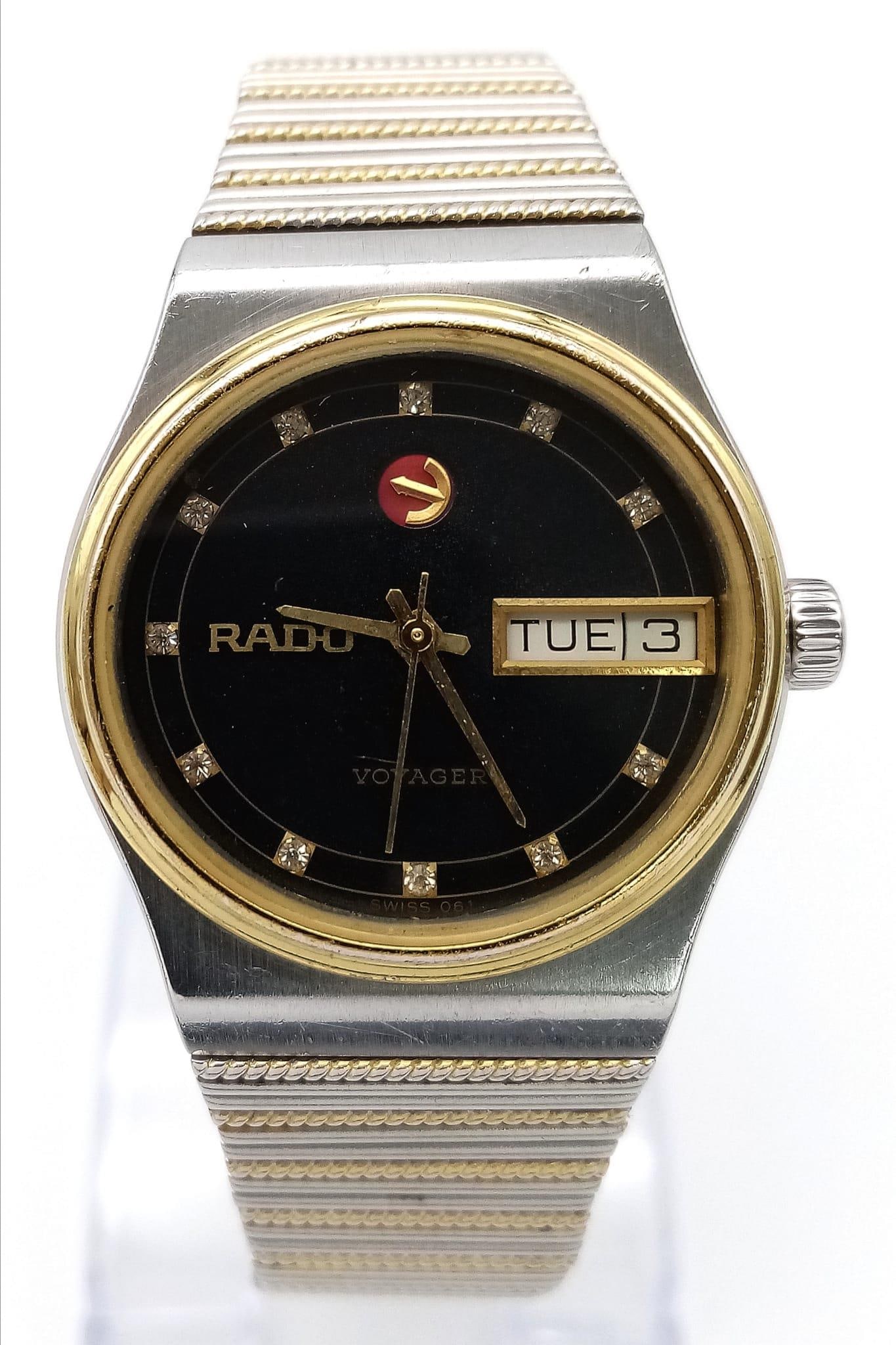A Vintage Rado Voyager Automatic Unisex Watch. Two tone stainless steel bracelet and case - 31mm.: A Vintage Rado Voyager Automatic Unisex Watch. Two tone stainless steel bracelet and case - 31mm. Black dial with day/date window. In working order.