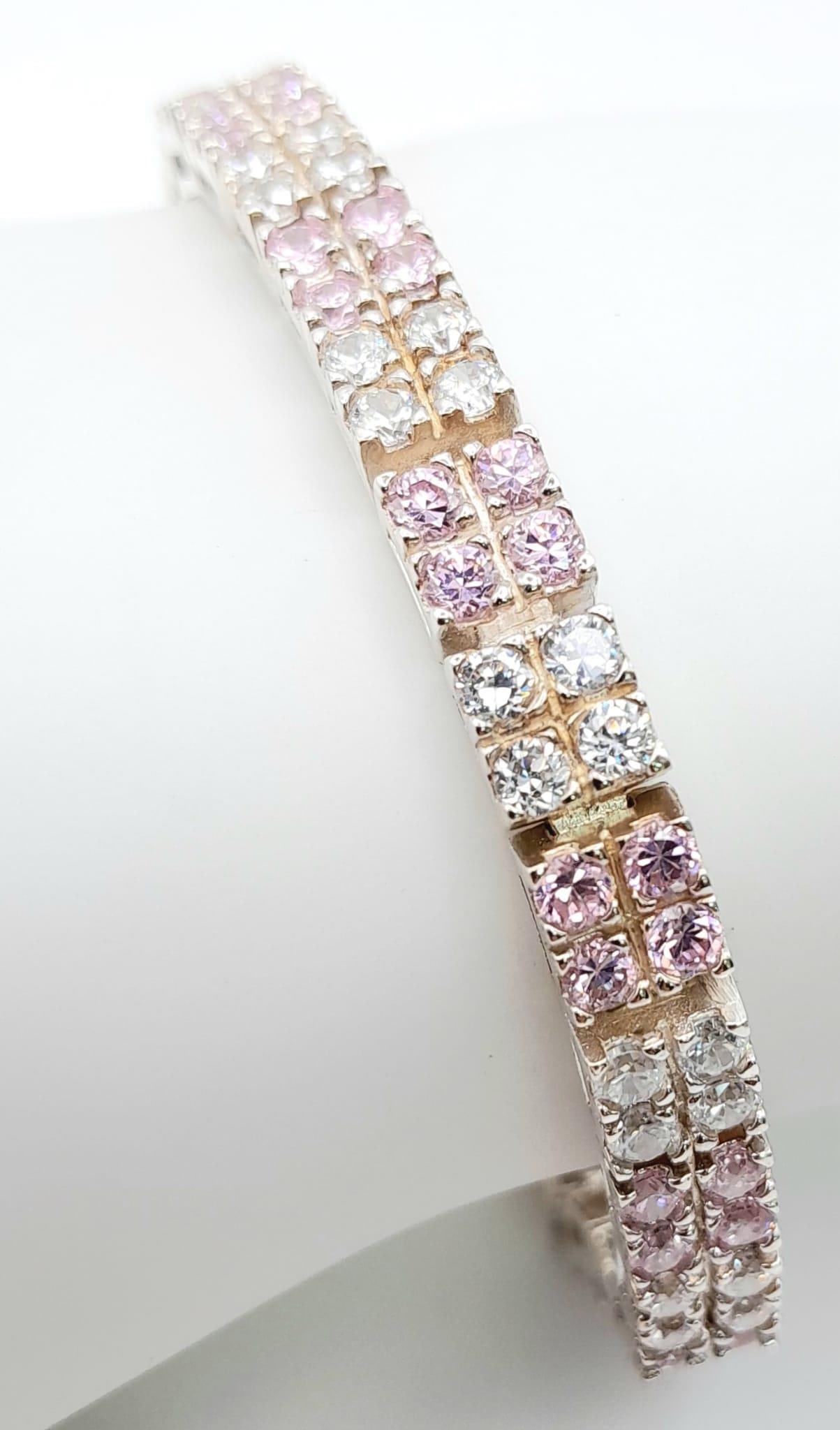 An Unworn Sterling Silver Pink & Clear Cubic Zirconia Tennis Bracelet. 19cm Length, 6mm Width, 22.88: An Unworn Sterling Silver Pink & Clear Cubic Zirconia Tennis Bracelet. 19cm Length, 6mm Width, 22.88 Grams.