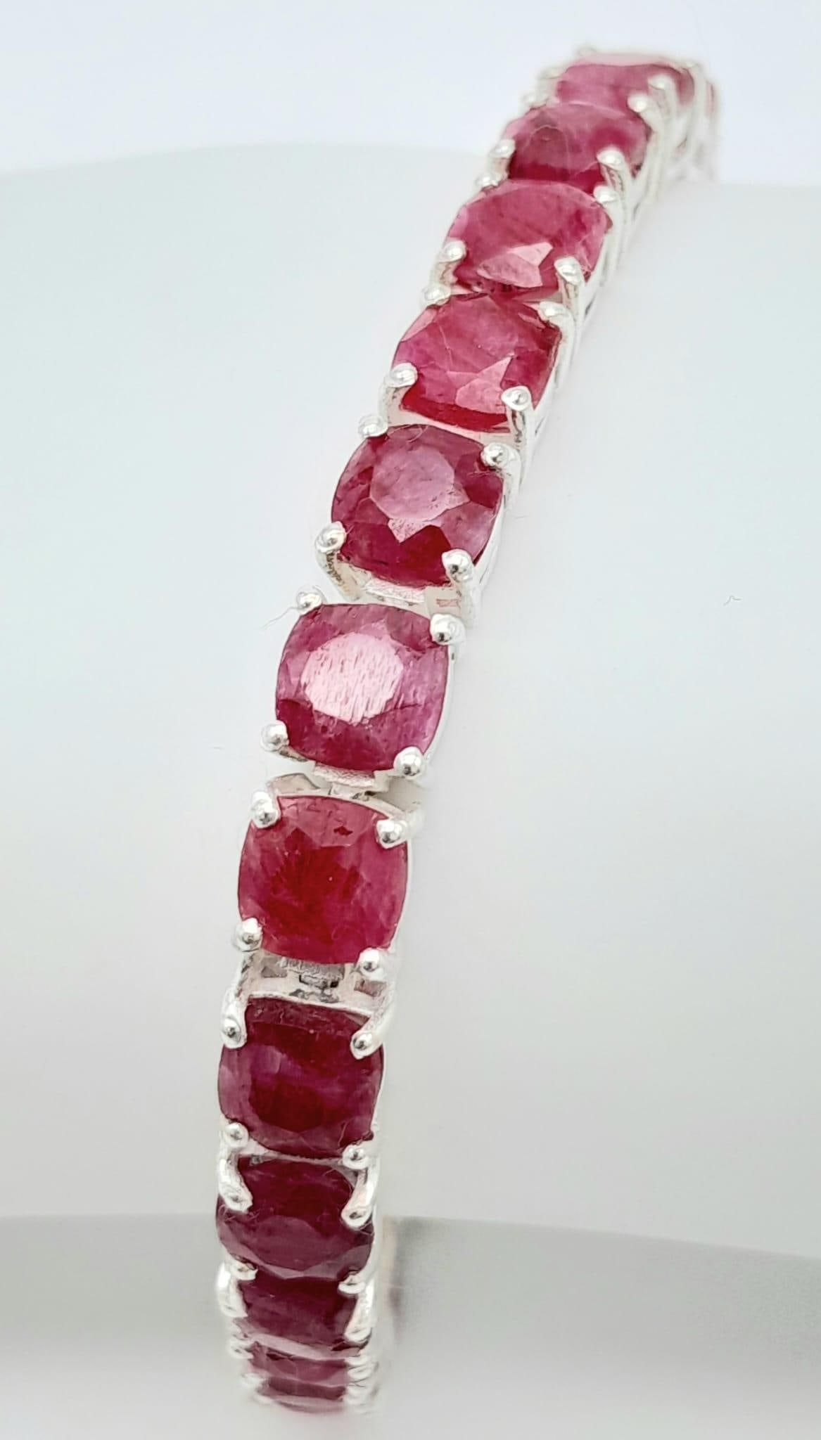 A Ruby Gemstone tennis bracelet, set in Sterling Silver. This delightful bracelet measures 20cm in: A Ruby Gemstone tennis bracelet, set in Sterling Silver. This delightful bracelet measures 20cm in length and weighs 21.02 grams.CD-1045