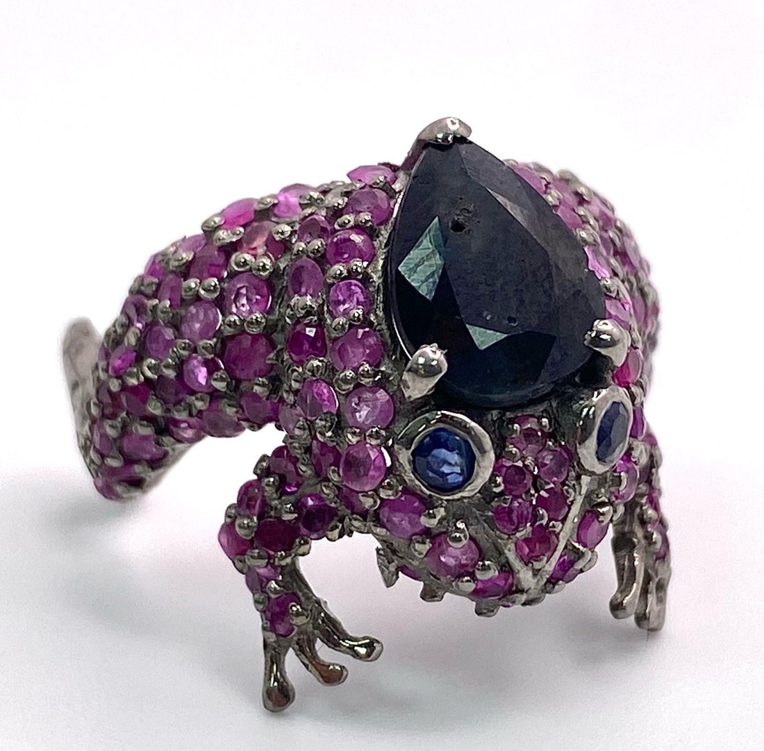 A Madagascan 'Jeremiah' Ruby & Blue Sapphire 925 Silver Frog Ring. 3.80ctw. W- 5g. Open ended - M/N: A Madagascan 'Jeremiah' Ruby & Blue Sapphire 925 Silver Frog Ring. 3.80ctw. W- 5g. Open ended - M/N Size. Comes with a presentation case. HV - 1743.