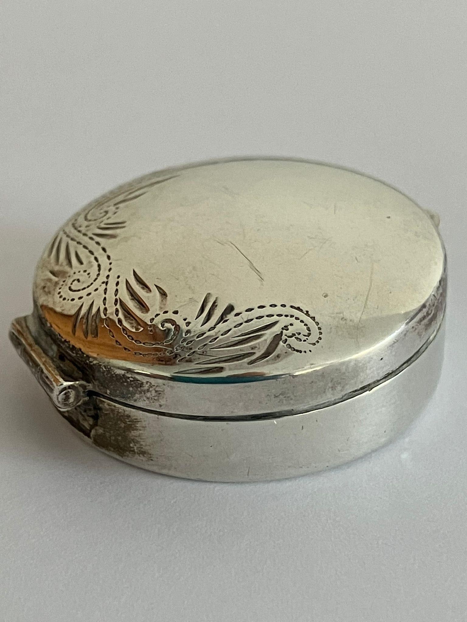 Vintage SILVER PILL BOX in circular form having scroll and foliate border. Lid opens and closes: Vintage SILVER PILL BOX in circular form having scroll and foliate border. Lid opens and closes perfectly. 3 cm diameter.