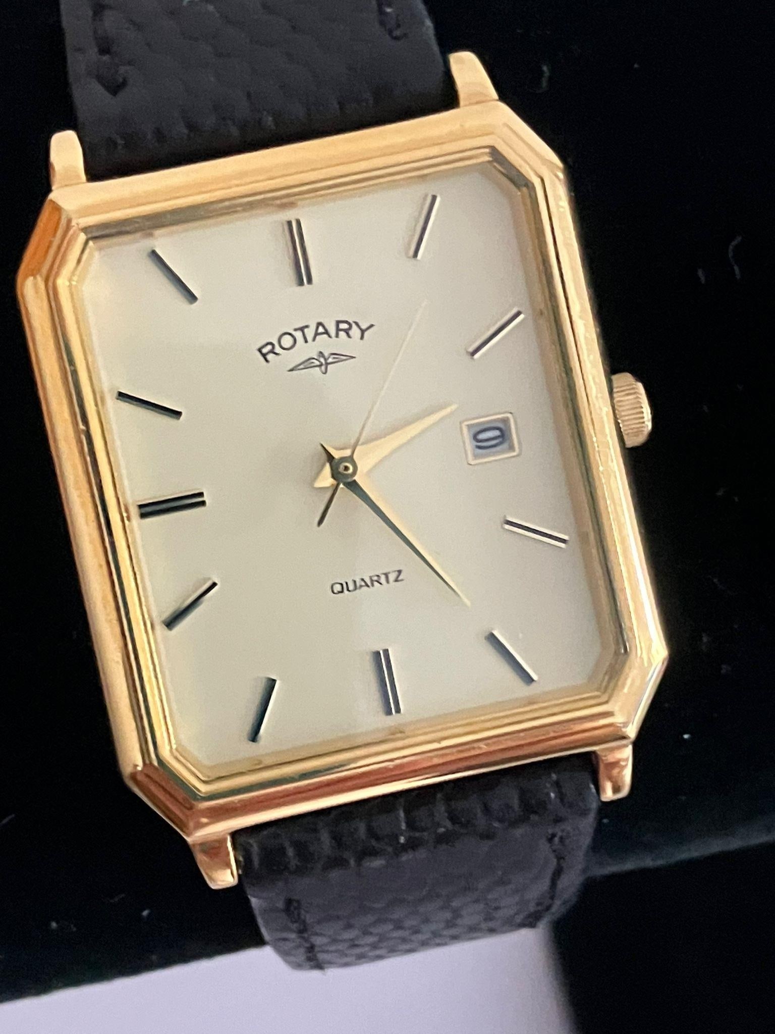 Gentlemans ROTARY QUARTZ WRISTWATCH model 4554. Finished in gold tone, having square face with: Gentlemans ROTARY QUARTZ WRISTWATCH model 4554. Finished in gold tone, having square face with second hand and date window. Black leather strap. Full working order. Excellent condition.