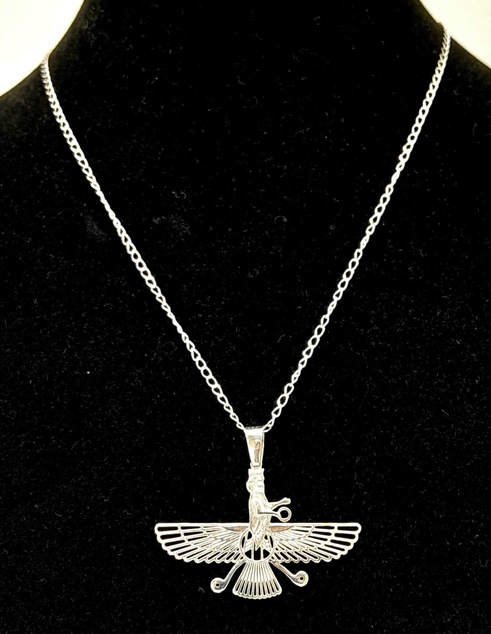 An 18K White Gold Zoroastrian Winged Deity Pendant on an 18K White Gold Disappearing Necklace.: An 18K White Gold Zoroastrian Winged Deity Pendant on an 18K White Gold Disappearing Necklace. Pendant - 3.5cm x 4cm. Necklace - 44cm. 5.5g total weight. Ref: 016026