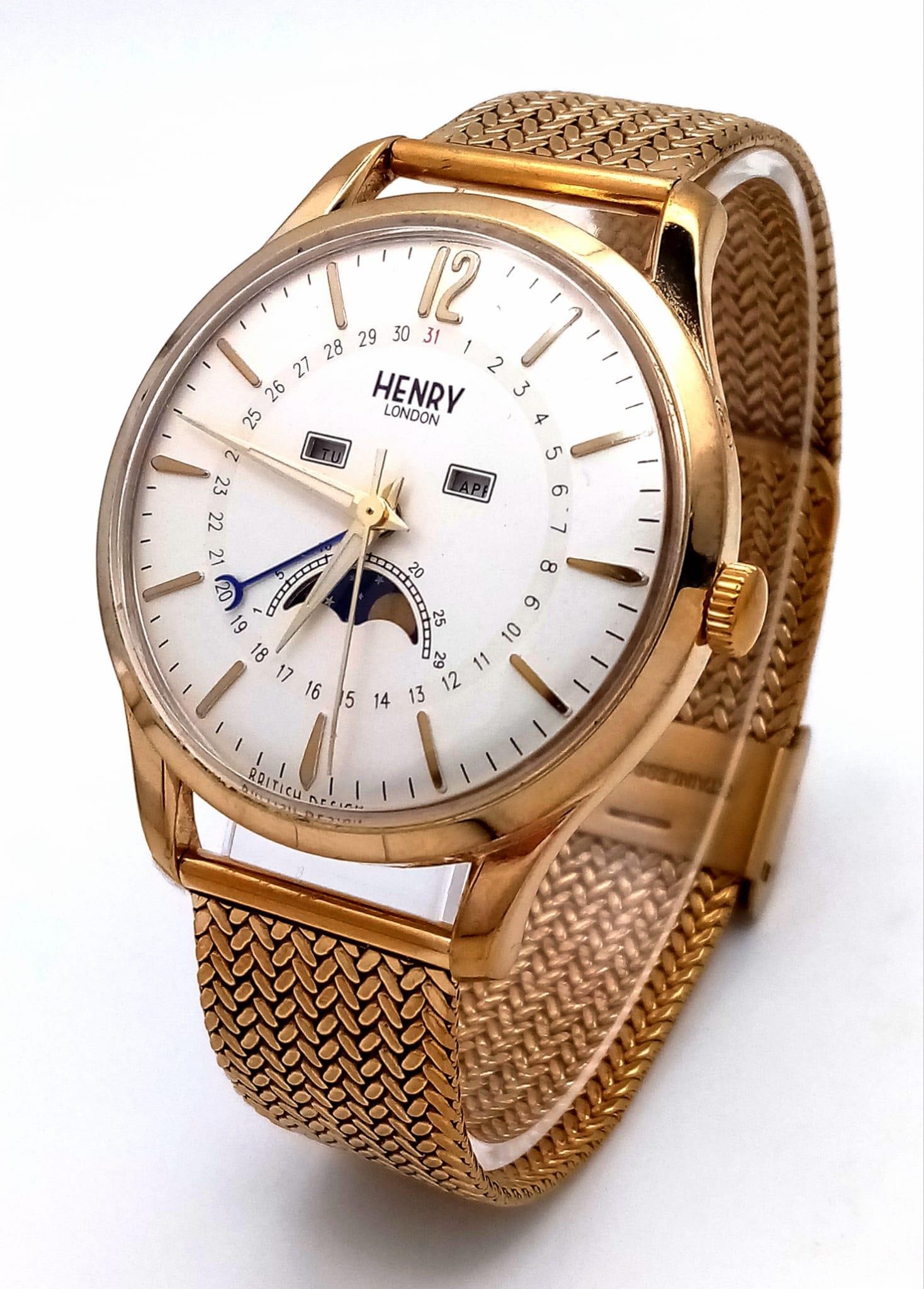 A Vintage Henry of London Automatic Moonphase Gents Watch. Gilded mesh bracelet. Two tone stainless: A Vintage Henry of London Automatic Moonphase Gents Watch. Gilded mesh bracelet. Two tone stainless steel case - 38mm. White dial with date and moonphase window. In working order.