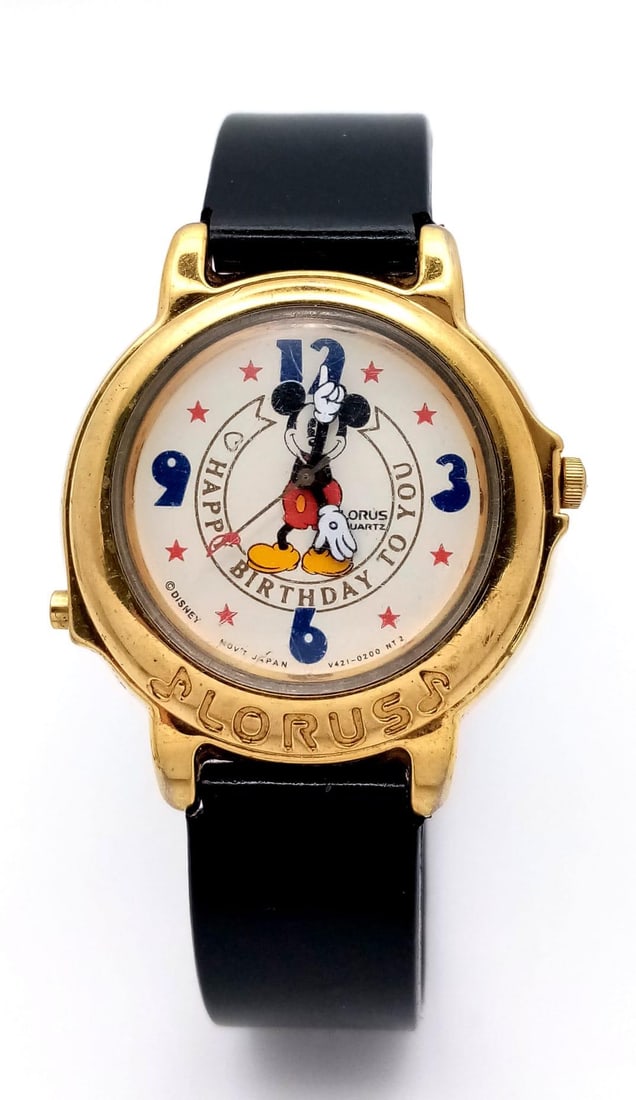 A Lorus Mickey Mouse Happy Birthday Quartz Watch. Black leather strap. Gilded case - 33mm. Mickey: A Lorus Mickey Mouse Happy Birthday Quartz Watch. Black leather strap. Gilded case - 33mm. Mickey Mouse decorative dial. Plays Happy Birthday. In working order.